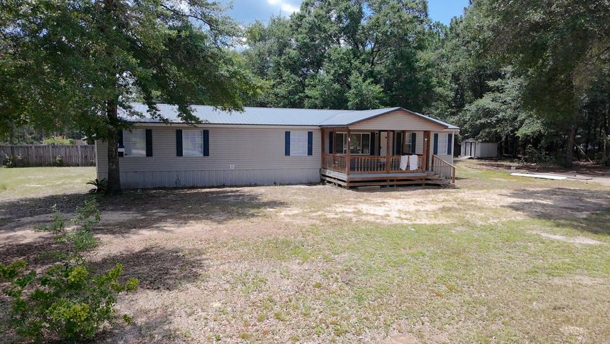 Looking for a home for a large family in a quiet neighborhood. This 4 bedroom 3 full bath plus extra office/bedroom manufactured home has been recently updated with new, paint,  new LVP floors, water heater, A/C unit. and much more. This home also offers a living room with a large den with fireplace that is open to the living room/dining area. Kitchen has an island and tons of cabinets! Large master bed and bath rooms and walk in closet New metal roof about 3 years ago. Paved road, Over half an acre corner lot, concrete parking area, yard building, close to schools, shopping, and several parks and lakes. Less than an hour to the beach.