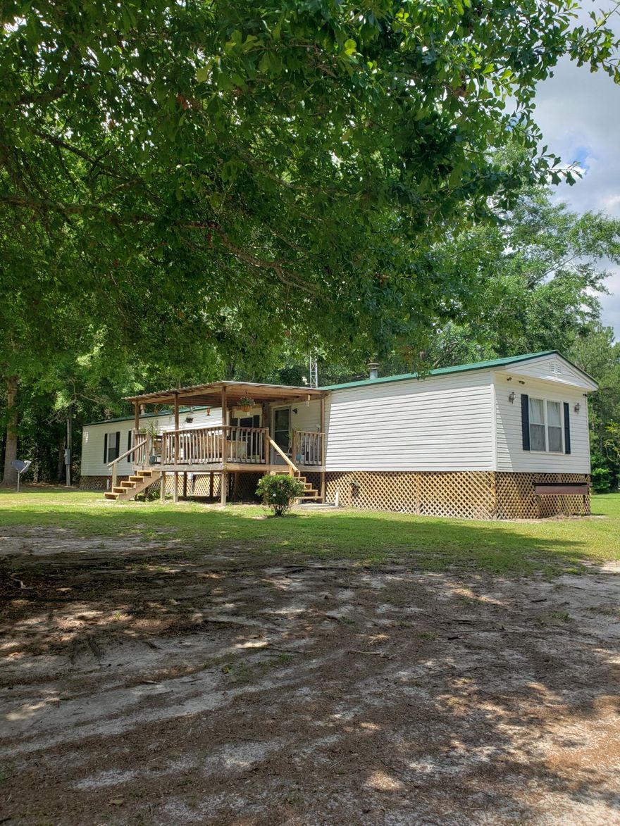 5 beautifully cleared acres with fruit trees, stock pond (bream and catfish), wildlife, and a small workshop equipped with electric wench. sink, a window a/c.  Must see this great opportunity to get a bit of country living. Just outside of Town and just 1 hour to the beautiful Emerald Coast Beaches.  Internet available