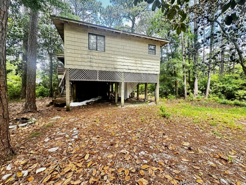 Calling all the investors, builders and fixer upper, corner lot with five buildable lots, and 3/2 house on a stilt that is in needs to be renovated.