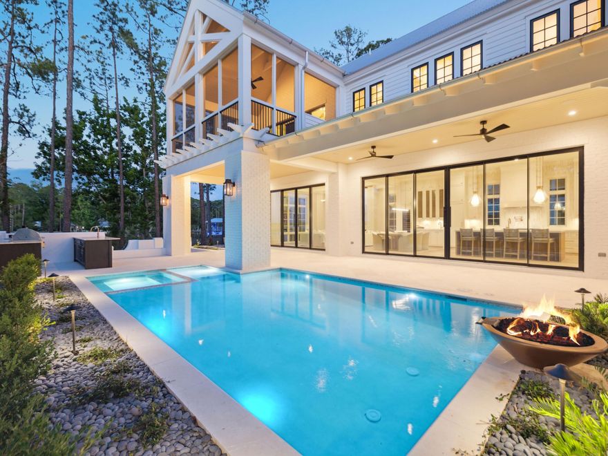 Framed by sweeping views of Churchill Bayou, the home offers a front-row seat to stunning sunsets and the serene rhythm of the water, visible from multiple vantage points throughout the property, including the main living area, primary suite, and expansive porches. Set within the exclusive gates of Churchill Oaks and with the option to purchase a 35-foot boat slip, this newly constructed two-story home embodies refined coastal living with timeless architectural style and upscale finishes throughout. Spanning more than 4,000 square feet, this four-bedroom, four-and-a-half-bath residence sits on a private 0.2-acre lot, thoughtfully designed to combine elegant comfort with seamless indoor-outdoor living. Inside, you're welcomed by a sun-drenched interior showcasing soaring beamed ceilings, expansive windows, and beautifully curated finishes. The heart of the home is the chef's kitchen, outfitted with custom cabinetry, quartz countertops, and professional-grade appliances. A generous center island anchors the space, ideal for entertaining, and flows seamlessly into a bright open-concept living and dining area with a cozy fireplace and tranquil views. The first floor features a serene guest suite with a spa-like bath and walk-in closet, while the primary and additional suites upstairs each offer private ensuite baths. Multiple covered porches and a private backyard oasiscomplete with a sparkling poolinvite year-round enjoyment under the pines. Set among the natural beauty of Churchill Bayou, Churchill Oaks offers a lifestyle unlike any other. Oak-lined streets, lush landscaping, and peaceful privacy define the community, while resort-style amenities elevate the experience. Residents enjoy access to a bayfront clubhouse, state-of-the-art fitness center, swimming pools, and a deep-water marina with 36 private boat slips. This is a rare opportunity to own in one of the most sought-after communities on 30A  where nature, design, and waterfront living converge.