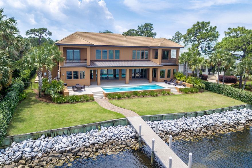 ONE OF A KIND BAYFRONT OPPORTUNITY IN REGATTA. THIS PRIVATE RESPITE LOCATED ON QUIET COURT IS A MODERN VILLA JUST 5 YEARS NEW. QUALITY CONSTRUCTION BY DKM CUSTOM HOMES AND METICULOUSLY MAINTAINED BY OWNER. INSIDE COURTYARD ENTRY THE CALMNESS BEGINS WITH TRICKLING FOUNTAINS AND MODEST XERISCAPING. FLANKING DOUBLE FRONT DOORS ARE ANDERSON IMPACT GLASS WINDOWS WITH BECKONING WATER VIEWS. ENTER INTO TREMENDOUS GREAT ROOM AND DINING ROOM ENTRY UNDER 21 FEET OF SOARING CEILINGS AND WALL OF WINDOWS OFFERING A TREMENDOUS VISTAS OF POOL AND BAY. CONTEMPORARY COOL AND NEUTRAL TONES CONTRAST MAHOGANY STAINED WOOD FLOORING THROUGHOUT. EAST SIDE KITCHEN FEATURES BLACK GRANITE, CUSTOM CABINETS, STAINLESS APPLIANCES, RECESSED AND PENDANT LIGHTING. WEST END FIRST FLOOR MASTER SUITE INCLUDES
