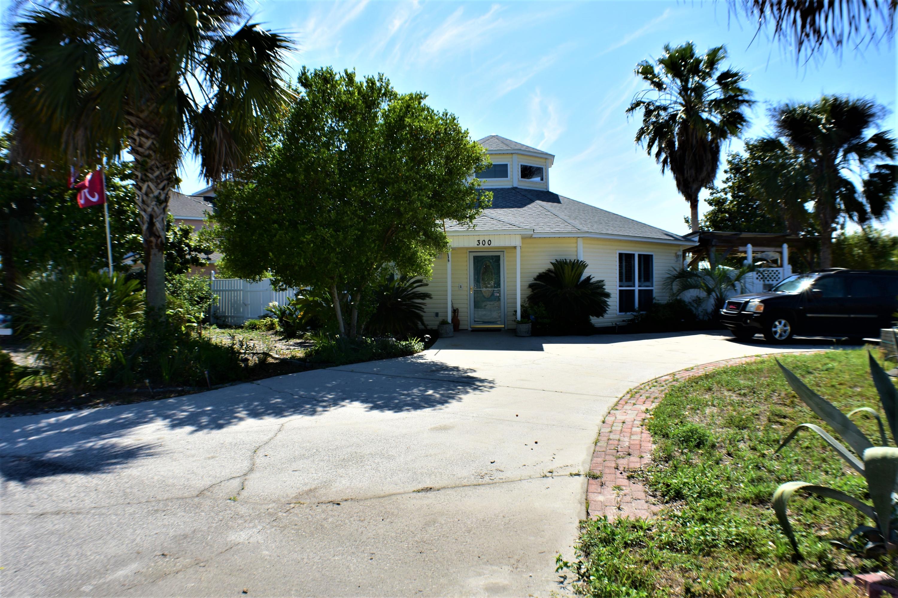 There is so much to this awesome property you literally have to see it in person to take in all that is has to offer! Just a few blocks from the dedicated beach, this Bid-A-Wee Beach home has 3 bedrooms, 2 baths and a backyard oasis ideal for entertaining! The home was custom built and offers a 1.5 year old roof, a split-bedroom floor plan, skylights, and all appliances convey including the washer/dryer. Outside you have a covered summer kitchen/grilling area, a bar, a SwimSpa, and a separate building that houses two workshops and a two car garage which you can access through a double gate on the back of the property. There are also several lime, lemon and kumquat trees along with other pretty indigenous flora dotting the landscape. A real backyard paradise! There is a circular driveway