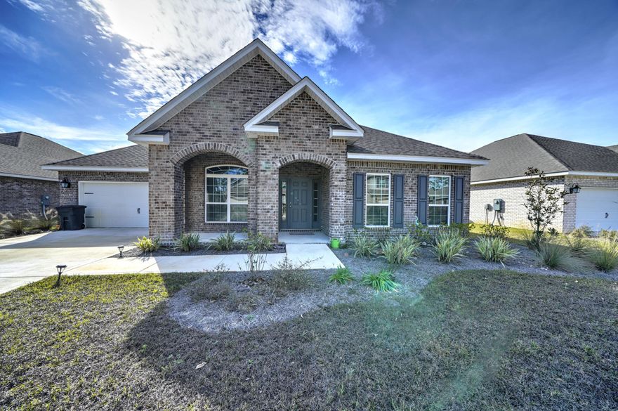 Beautiful nature inspired living only 5 min to the beach! Gorgeous 5 bed/3 full bath home. Must See. Upgrades include a custom stove hood, gorgeous back-splash, privacy fence, plantation blinds throughout, and all stainless appliances! This popular McKenzie 3000+ SqFt floor plan has 9 foot double treyed ceilings, hard wood floors, designer lighting, granite in kitchen and all baths, irrigation system and landscaping. Spacious covered front porch, grand open foyer, light filled office/den and formal dining room. Open living includes a gourmet kitchen, casual dining area and great room with tons of light. Huge Master bedroom sits at the back giving it separate access to the porch. The spa-like master bath has dual sinks, separate tub & shower, spacious walk-in closet. 4 additional bedrooms