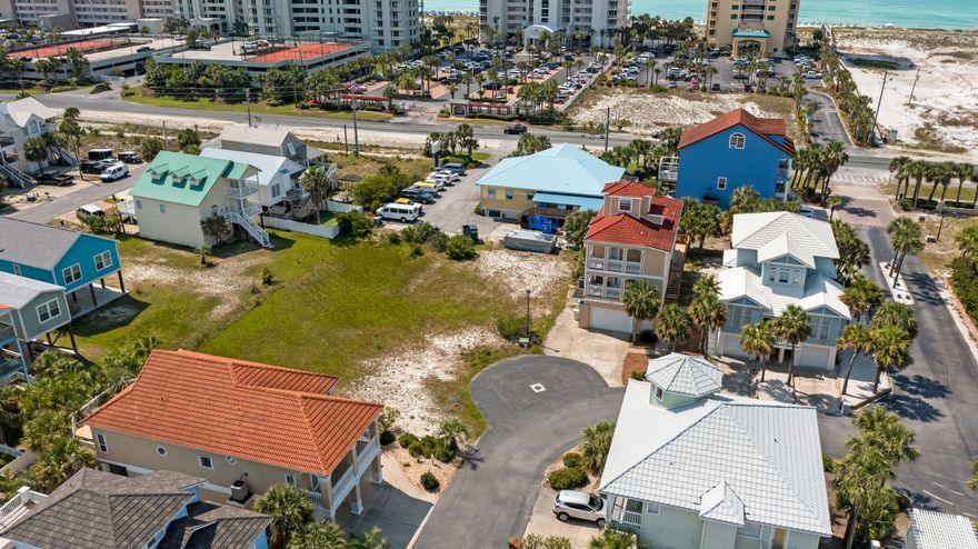 Welcome to the Village at Navarre! One of the most sought-after neighborhoods on Navarre Beach! A private quaint waterfront community, just a short walk from the sugary white sands of the Gulf of Mexico. Perfectly located on the Sound Side, offering the convenience of being close to dining, shopping, and events on the beach. Village at Navarre does NOT have RENTAL RESTRICTIONS and features a community pool, private beach on the sound, dock, and pier. The newly finished dock is equipped with power, water, and a fish cleaning station. If you love living the beach life, then now is an exciting time to build your dream home or a ''rental powerhouse'' STR.