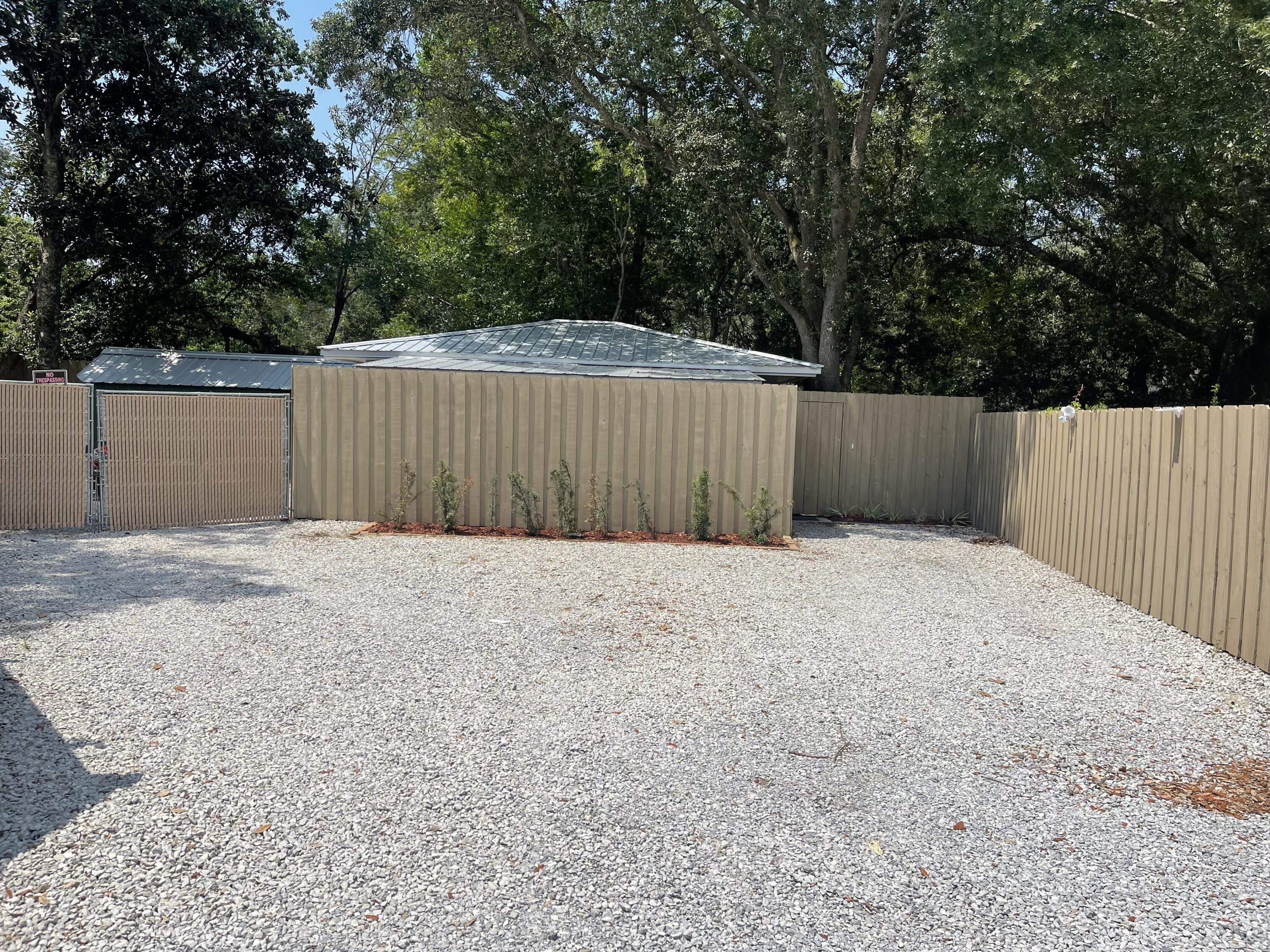 Secluded, Private one bedroom, one bath, unfurnished annual rental. Cottage is separated, located on side and rear of main house, with its own parking & gated entry. Monthly rent includes water, sewer, garbage and electric. Freshly painted and clean. Stacked washer/dryer is included. Screened in porch at entry provides an area for smokers or relaxing. Only one person and one car permitted.