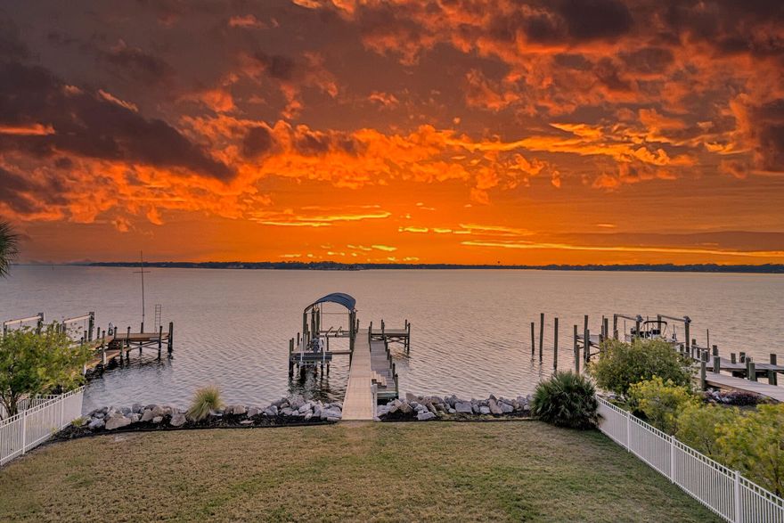 Welcome to your dream waterfront paradise at The Pointe - a hidden gem nestled in a small, exclusive gated community on the pristine shores of the Choctawhatchee Bay in Shalimar, FL. If you've ever yearned for a life where stunning sunsets, boating adventures, and luxurious living converge, this 4-bedroom, 3.5-bath masterpiece is calling your name! As you enter, you'll immediately notice the sheer quality and attention to detail that defines every inch of this home. LVP and tile flooring run seamlessly throughout, setting the stage for elegance and easy maintenance. With an elevator servicing all three floors, this abode caters to the convenience of modern living, making it accessible to everyone. The house has been updated with fiberoptic internet for the fastest upload speeds possible.
