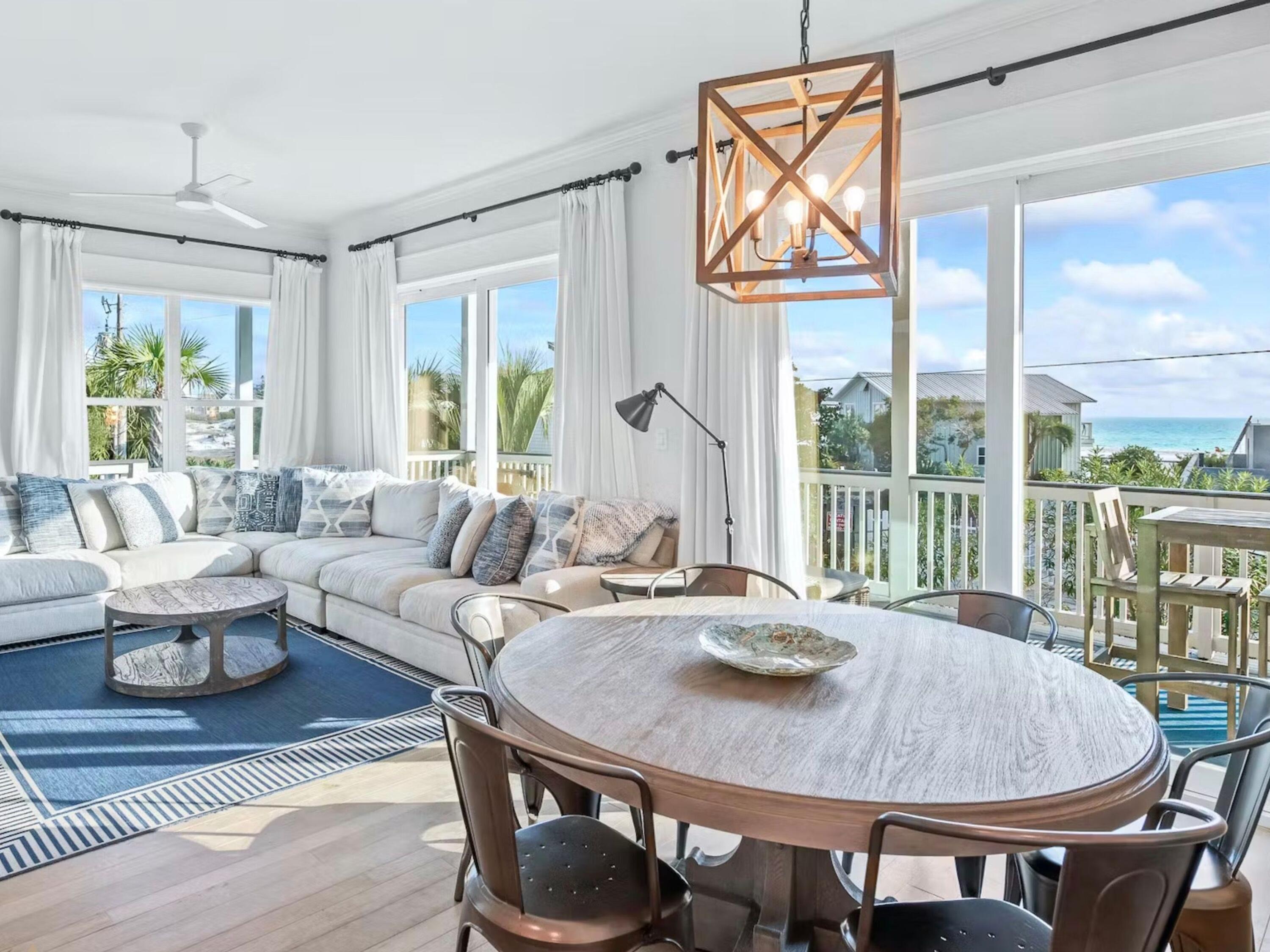 Superbly located in the heart of Seagrove Beach, this seven-bedroom beach house has been fully renovated and expanded to create a multi-generational vacation home with stunning gulf and lake views. The meticulously designed layout combines with harmonious coastal decor to create a luxurious home exuding a comfortable contemporary vibe. Three floors include a private lock-off on the ground floor with its own guest rooms, living room and new kitchenette with quartz-topped dining island. It has ground-floor access and a private shady porch for alfresco living. Hardwood flooring and shiplap walls reflect the natural surroundings. The second floor accommodates the main dining and living areas which flow seamlessly outdoors onto the extensive wraparound deck.