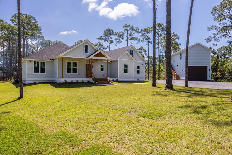 Ask how to lock-in 6.5% Interest with Seller concession of $11,220.00. Must use Preferred Lender.  Elegant Custom-Built Modern Farmhouse Design with Carriage House awaiting you! Beauty and serenity are the hallmarks of this superbly situated 1.75-acre waterview estate with paved driveway leading up to Home Sweet Home!  All are a short distance to White Sandy Beaches of Florida's Emerald Gulf Coast & very close proximity to Choctawhatchee Bay public launch at end of Don Bishop for access to Choctawhatchee Bay. This Stunning home is 2,931 sqft consisting of 5 bedrooms, 4.5 baths w/ flex room AND the Carriage house is 800 sqft incorporating 2 bedrooms, 1 bath w/ 800 sqft garage. Altogether 7 bedrooms, 1 flex room, 5.5 baths making up approx. 3,731 sq ft w/ huge 800 sqft garage. This garage is ready for your sizeable RV/Motorcoach or Boat w/plenty of parking available.

As you venture inside this glamorous home with its golden, crisp, clean touches everywhere, you will be amazed! You will observe each room offers ample room for everyone, crown molding and can lighting throughout. An open floor plan boasting a significant dream kitchen, dining, and living room with high ceilings to achieve a layout ideal for relaxing and entertaining. Cook up a storm in the amazing kitchen showcasing a gorgeous wood ceiling and trim with beautiful beams. It features a large island with farm style sink, quartz counter tops with lovely tile backsplash, abundance of cabinetry and classy stainless-steel appliances. Topped off with a huge walk-in pantry and butch-block counter.  For convenience the laundry with butcher-block countertop sits off the kitchen in hallway next to the half bath.

The extraordinary primary bedroom and its en-suite bathroom is a wonderful refuge at the end of hard days' work. Refresh in the lovely large elegant, soaker tub with surround tile or in the Grande tile shower.  Get ready with separate stand-alone vanities, ample storage cabinets and easy access to huge walk-in closet. Also accessible at this end of the home is the upstairs 2nd floor.  You will find a very large Flex/Bonus room, which can be another bedroom, office or exercise room.  One additional bedroom with en-suite full bathroom.

Three additional bedrooms on the first floor are located at the opposite end of the home down an oversized hallway. One has an ensuite full bathroom, while the other two share hall bathroom.  

Venture over to the Carriage House moving up to the 2nd floor and you enter into a large open concept living and full-scale kitchen area, (2) bedrooms and 1 bath. Guys! We have an extra-large 800 sqft garage for you. It offers plenty of space for boats, kayaks, fishing tackle and more! 

Carriage House Garage Info:
Garage door opening is 11' High by 15.5' wide.
Ceiling inside is 13' tall
Interior walls are approx 19' X 39'

The backyard offers an abundance of space for you to design an extraordinary outdoor space overlooking a picturesque pond. To get you started, the backyard oasis boasts a large, covered porch with 30' x 15' SALT-WATER pool & water fountain surrounded by black rod iron fence. The pool's multi-colored lighting adds evening and nighttime ambiance to any gathering. Beautiful Gazebo complete with 42" PAPABABE 42" Outdoor Fire Pit w/2 grill, wood burning firepit. Do you have a green thumb? Looking for ample yard space for gardening, planting your favorite fruit trees and more. Experience bit of country life in the city!!  

This place exudes fun and relaxation! Fusing comfort and functionality, this custom-built residence offers the perfect balance of backyard living and elegant design sensibility. There's no way to fully describe all this property has to offer, it must be experienced, and I know it will not disappoint! 

Bring your boat and RV/Motorcoach and more.  There are minimal restrictions and small yearly HOA dues of $75.00.

Irrigation Well is 40ft deep feeds lawn irrigation around the home.
City Water/City Sewer taps paid.
One Year builder warranty. 
Flood Zone AE.  Flood Insurance required.

A few mentions of importance...
Woodland Bayou Estates' 4.30 acre Community Waterfront park is located on Bayou Drive offering waterfront views for the residence to enjoy! 

The location makes this home incredibly attractive to folks who are looking for great fishing and/or cruising on the Choctawhatchee Bay or spending the day on Florida's White Sandy beaches (10 mins). There are numerous bayou boat launches leading to both the Bay and Gulf where one can enjoy fishing, canoeing and watersports and more. Did I mention you are a few short miles away from the world-famous Crab Island in Destin or spending the day taking in the Florida sun on one of our area spectacular beaches of Destin, Miramar, Santa Rosa Beach, 30a, Panama City?

Buyers to verify all dimensions and property information of importance.