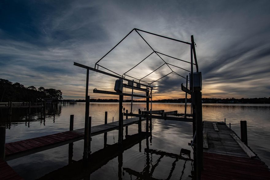 Rare investment renovation opportunity in sought after WATERFRONT community with million dollar view. In Poquito Bayou, the most desirable area in Shalimar. Shalimar is a great location, close to Eglin Air Force Base, this home sits on almost 100 feet of beach. One of the few properties that doesn't have a seawall and has a natural beach. It is over 14' above the water, no flood insurance required. The home needs some work. Protected deep water with a boat lift. Bring us an offer!http://www.heritagehomesfamily.com/office/fl/designs.phpPlease use the link attached to get an idea of some newer homes that would look great.