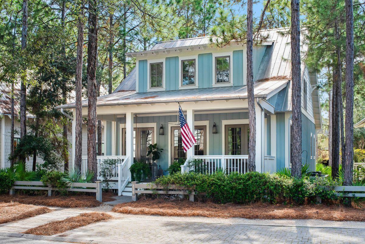 Tucked in Phase II of WaterColor, this bright beach retreat offers tranquil outdoor living spaces and close proximity to community amenities. Well maintained, the home features an open floor plan with inviting living areas, beautiful hardwood and tile flooring throughout, and updated furnishings. A chef's kitchen overlooks the dining area and features granite countertops, stainless steel appliances, a breakfast bar, and white cabinetry with plenty of storage. Ideal as a primary residence, second home, or investment property, this home offers 2,532 square feet of living space, a suite on the main level, two suites upstairs, and hall bunks for additional accommodations.