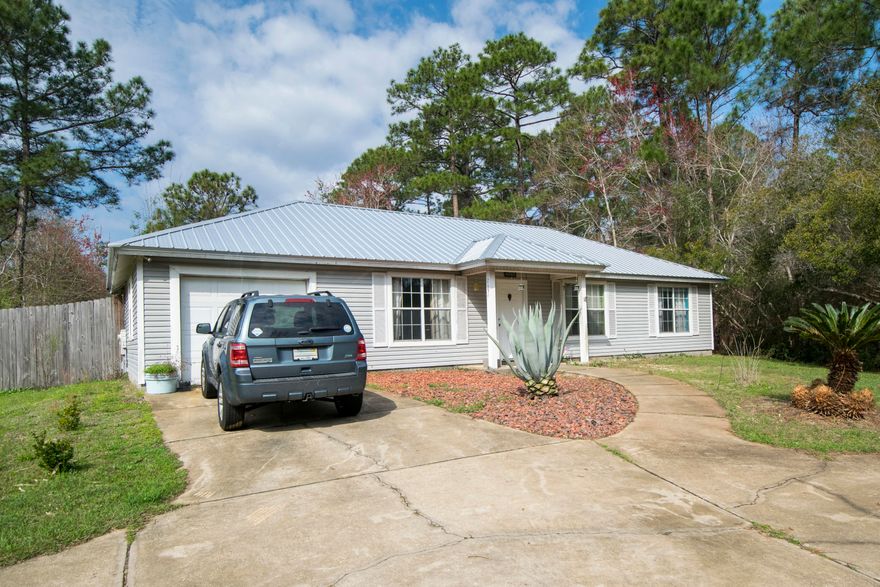 Wonderful home located on a double lot along Chat Holly. Brand NEW METAL ROOF was installed February of 2018. Perfect for a full time resident or 2nd home. This home is perfectly laid out with a large living area that flows right into the dining and kitchen. The attached garage opens into a separate laundry room. Since the home is one level, all bedrooms are ground floor with no stairs. The backyard is HUGE as the home sits on a double corner lot that is almost 1/3 of an acre. Please call for details and a showing!!