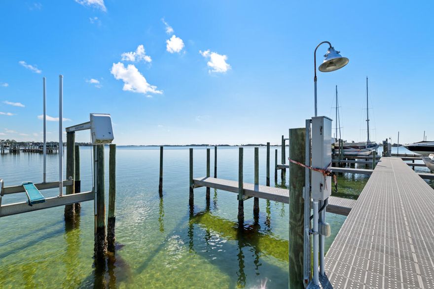 Whether you're looking for your next short or long term investment property, or you're a boater looking for your own waterfront getaway - this 2 bedroom, 1.5 bath townhome in La Mar West Townhomes in Mary Esther is waiting for you! The WATERFRONT community of La Mar West Townhomes features a community pool, tennis courts, clubhouse, boat dock, and a small, private beach for owners and guests - perfect for kids, kayaking, fishing, and more! Ownership for this unit includes your very own deeded BOAT SLIP! Perfect for taking off into the Sound to head out to the Gulf for a nice outing or fishing trip! This furnished and updated 2 story unit features a washer and dryer, 2022 Water Heater, 2023 Roof, 2023 HVAC, and tiled and LVP flooring throughout. The sliding glass door leads to the patio with a fantastic view of the community pool.Upstairs is the full bathroom, spare bedroom, and primary bedroom with its own private balcony to relax and enjoy your morning cup of coffee with a wonderful view. This unit is also equipped with an Electric Vehicle charging plug out front by the 2 assigned parking spaces. Schedule your showing today, and make this FANTASTIC property yours!