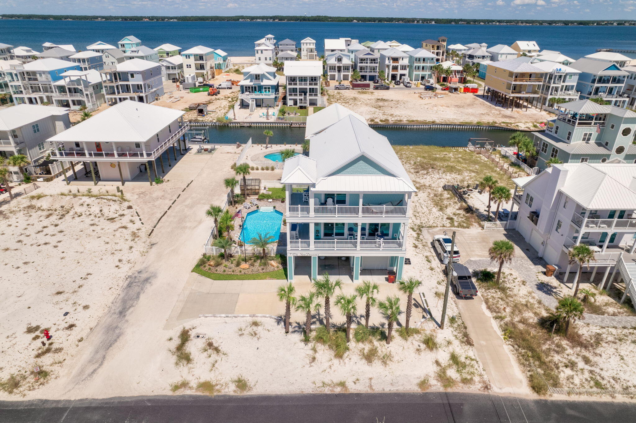Beautiful Gulf views * 4 BR/ 3.5 BA * Pool * Canal access with boat lift * 25 yds to Beach Access, 75 yds to National Seashore * Rated to 180 MPH winds * No HOAWelcome to your dream coastal getaway! Located on the highly desirable west end of Navarre Beach, this gorgeous 4-bedroom, 3.5-bathroom home offers unique luxury, stunning views and the best of both worlds with Sound access via the canal and close proximity to the beach access. Just 75 yards from the undeveloped National Seashore and a mere 25 yards to the public beach access, this property combines privacy with convenience, placing you steps away from the pristine beauty of Navarre Beach.Built in 2022, this 2,948 sq. ft. masterpiece is rated to withstand 180 mph winds, ensuring both safety and peace of mind. The open-concept design features expansive doors that frame gorgeous Gulf views right across the streetwhile multiple extended decks offer perfect vantage points to enjoy every angle of the stunning surroundings from Gulf to Sound. Watch sunrises and sunsets from the comfort of your front porches.
The chef's kitchen is a highlight, boasting exquisite quartzite countertops, top-of-the-line Viking range, and a massive island ideal for meal prep and entertaining guests. A generous walk-in pantry and ample cabinet storage cater to all your organizational needs. Wood look tile flooring and detailed finishes like crown moulding and gorgeous tile backsplashes offer unique touches with durability and warmth that will appeal to the most discerning tastes. All of this set in a soothing, beachy palette and roomy floor plan offers the ultimate space to unwind or to congregate with friends and family.
Convenience is key with an elevator servicing all levels of the house, and the amazing outdoor kitchen with a half bath makes hosting gatherings a breeze. Privacy is ensured with the fully fenced yard. Enjoy days by the pool with Coolaroo shades to create just the right amount of sun protection, then evenings by the firepit on the manicured lawn with well water irrigation. Or explore the Santa Rosa Sound and beyond via the easement to the canal with an existing boat lift for your aquatic adventures. A 30 minute boat ride from your back door will get you to Crab Island or to Pensacola Beach/ Ft Pickens to spot the Blue Angels.
This coastal haven also features a greenhouse for your gardening passions, ensuring that every aspect of luxury and comfort is covered. Perfectly placed outdoor lighting provides the most beautiful highlight in the evenings.
Don't miss this rare opportunity to own a piece of paradise in Navarre Beach.
Contact us today to schedule your private viewing!