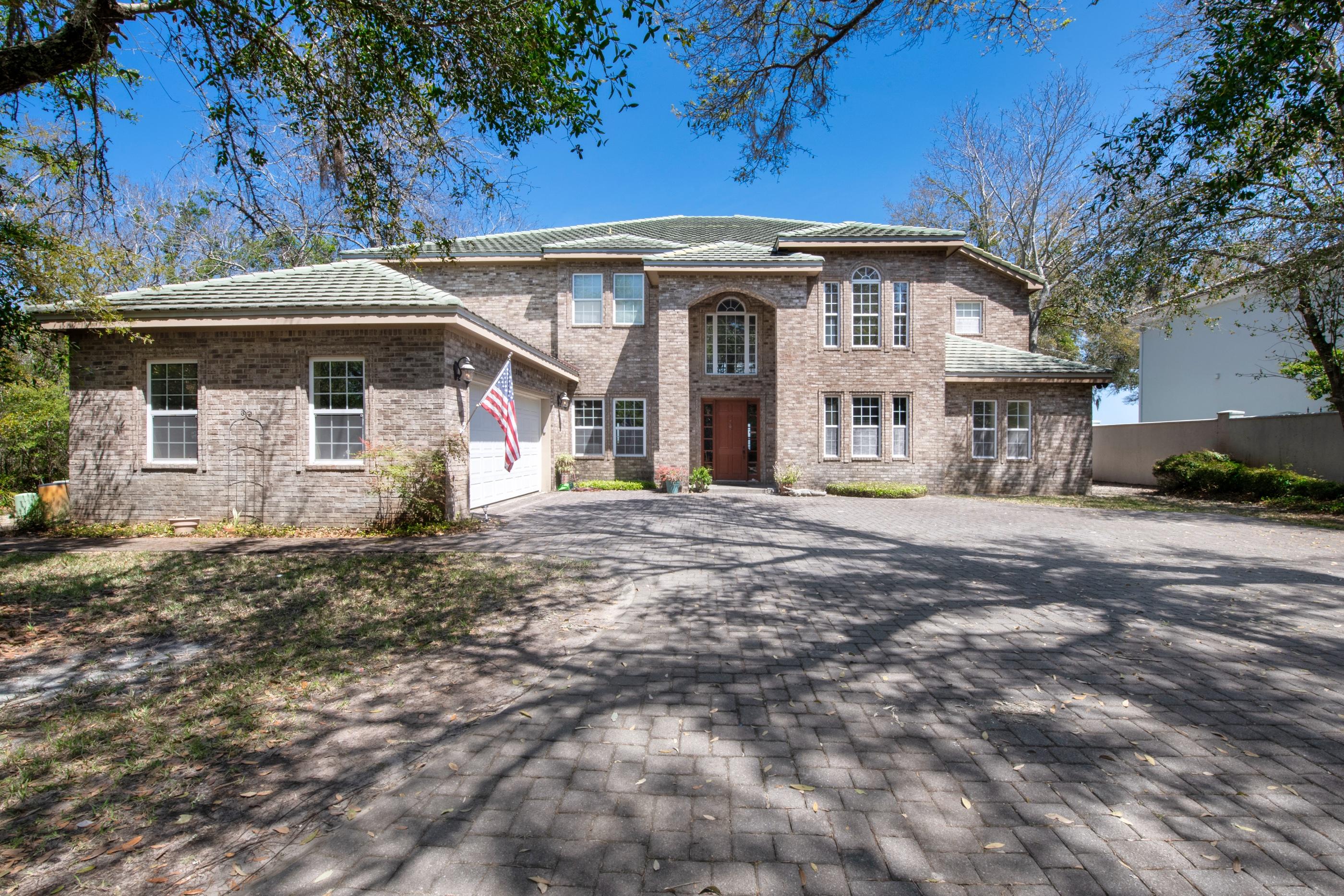 Beautiful estate winding through established oak trees on a brick paved driveway with over 5300 sq ft of living space. An amazing 2 story, brick home sitting on 100' of Choctawhatchee Bay. As you enter into the home, you are greeted with over 19' ceilings, travertine tile throughout the home with exception to the living room and master bedroom suite with Brazilian Cherrywood floors. A grand staircase leads you to the second floor with iron railings or take the elevator from the Butler's Pantry / laundry room just off the kitchen. First floor has a study/office with built-in stained book cases over 8' tall, the living room expands to over 19' ceilings, gas fireplace with views of the bay. An open floor plan encompass the breakfast area and gourmet kitchen, all have a view of the bay.