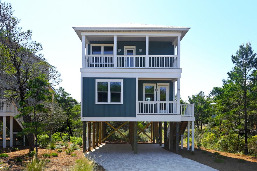 Beautiful 2 story home on pilings just a block from the beach. This 4 bedroom 4 and a half bath has a great layout. Downstairs has one bedroom with a huge living area and kitchen. Upstairs hosts 3 bedrooms and all have their own bathroom inside the room. Hardwood throughout the house with tile work in the bathrooms. Granite throughout, stainless steel appliances, impact windows and doors... this home has all the finishes you are searching for.