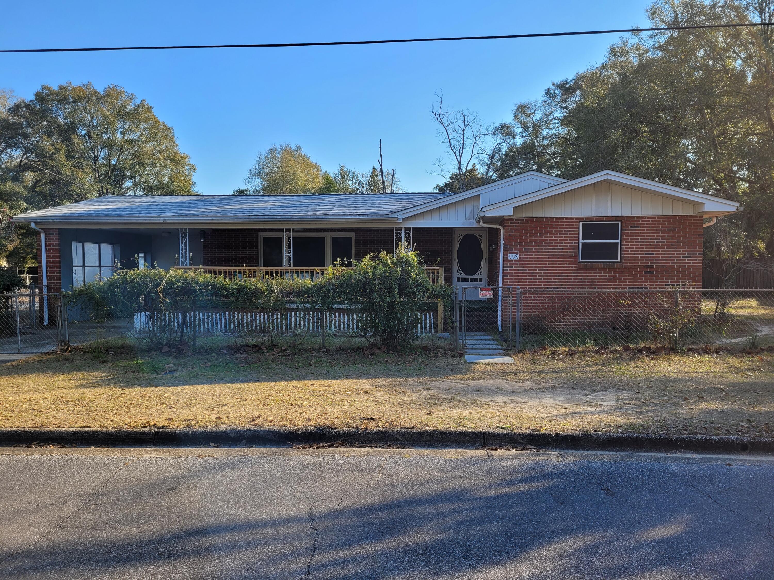 Handyman/Investor Special. Although this home needs some work, it makes for an affordable option for someone with energy and skills. This is a charming brick home that sits on over 1/2 acre (6 city lots). The kitchen has solid wood cabinets and a gas stove. The front porch is a perfect place to enjoy your morning or afternoon beverage of choice. The entire yard has a chain link fence. The home has a carport and also a large parking pad along with a nice storage shed. The utility room has washer and dryer hook ups and built-in shelving for storage. Conveniently located in town. Buyer(s) will need their own funds with cash, hard money or private investor....as this house will not go regular loan.