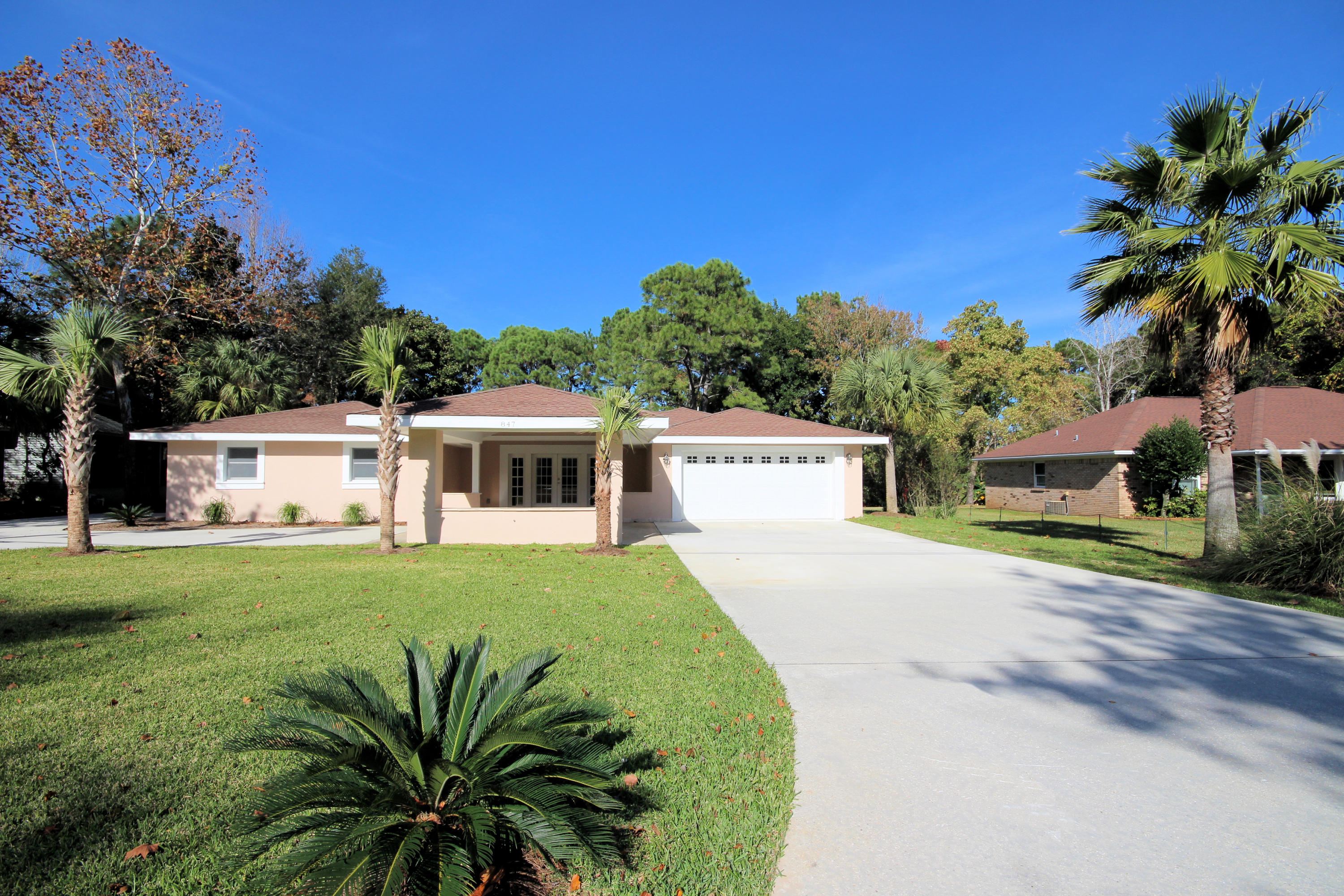 This home has been completely remodeled, updated and is move in ready! Nearly 3500 Sq.Ft home in the heart of Destin with 43 Sq.Ft acres on a lake featuring a drive through porte-cochre. You will fall in love with the open floor plan, tray ceilings, travertine tile flooring, quartz counter tops throughout, brand new stainless steel appliances, brand new touch sensor toilets, mini bar in the great room, the florida room, two extra large walk in master closets with built in cabinets, walk in closets for both guest bedrooms and the large deck off of the back of the home overlooking the lake. The back yard is an outdoor oasis and you will have your own private dock, where you can paddle board, canoe or just relax. The large backyard would be perfect for a pool!