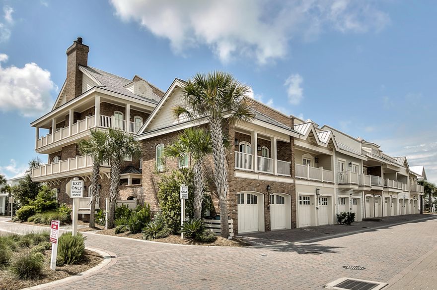 This is a special luxury townhome on the Gulf side of 30A featuring 5 bedrooms, a carriage house, a courtyard, two car garage, elevator, balconies off of every bedroom, and all just a few steps from the shops and restaurants at the Hub. Additionally the home was built using Insulated Concrete Form construction which means it is quiet, strong, and efficient. This end-unit welcomes you in with a spacious kitchen, open living area, and a dining room on the first floor. The second and third floors feature a large master and guest bedroom each with ensuite bathrooms. Every bedroom also has access to its own porch. The courtyard is an ideal place to enjoy a meal or wind down from the day. The carriage home kitchen has a full size oven/stove and is perfect as guest quarters or a separate rental.