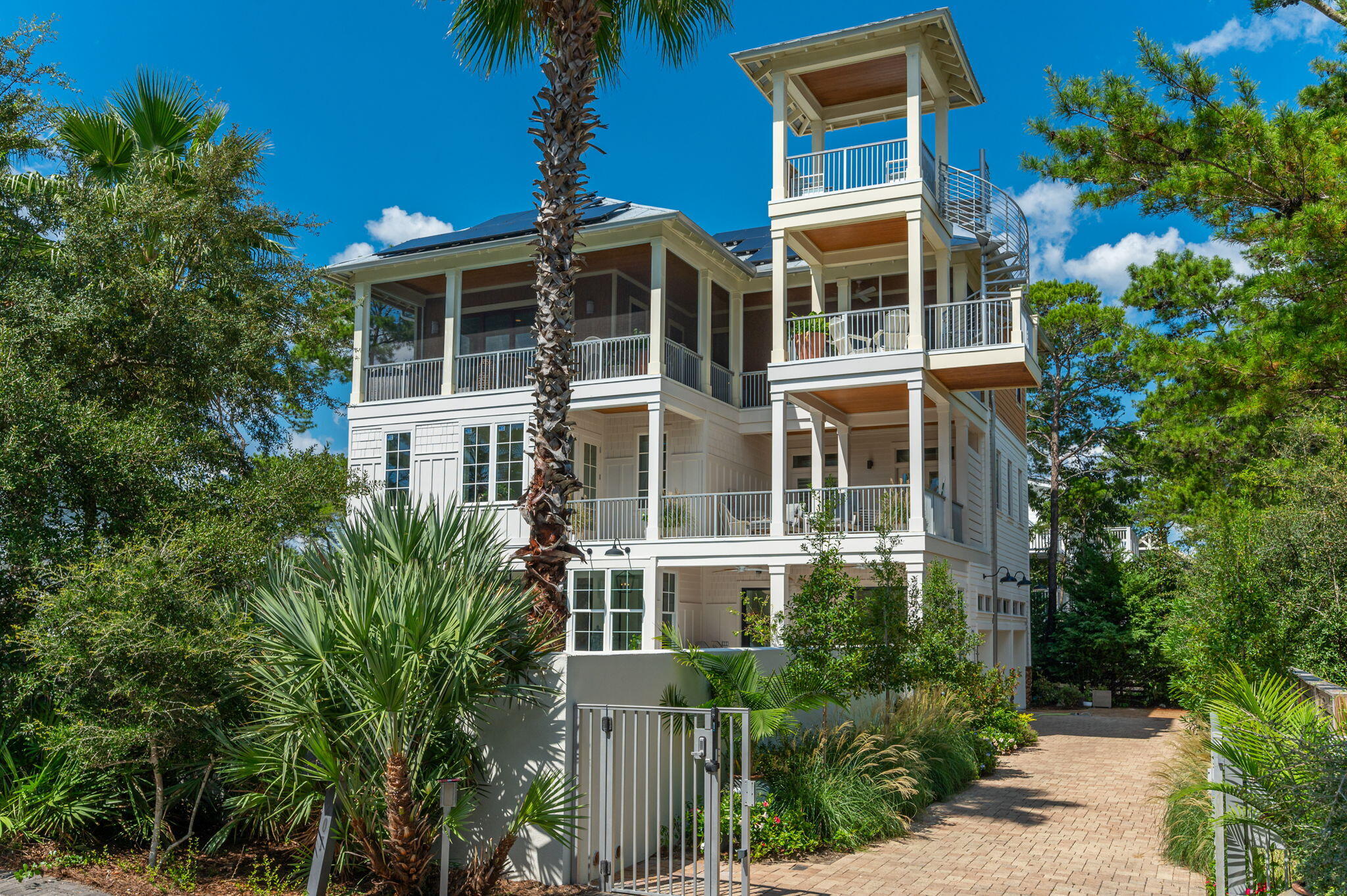 The views! Draper Lake and the Gulf! 36 feet above sea level and constructed of concrete, this stunning home is thoughtfully renovated by award winning Chicago designer Victoria Lidstrom of Leggy Bird Designs. SOUTH of 30A.     Nestled on a serenely quiet dead end adjacent to Draper Lake!!!  Two blocks from the Gulf and NO HOA!    Stunning views from every floor...including sparkling sunrises over Draper Lake, the Gulf of Mexico sunsets and a private secluded walled garden with 36 foot crystal blue pool and gas firepit. Resort style amenities provide ultimate Entertaining with 2 New kitchens on the third and first floors! 4 new gorgeous spa baths and pool shower.