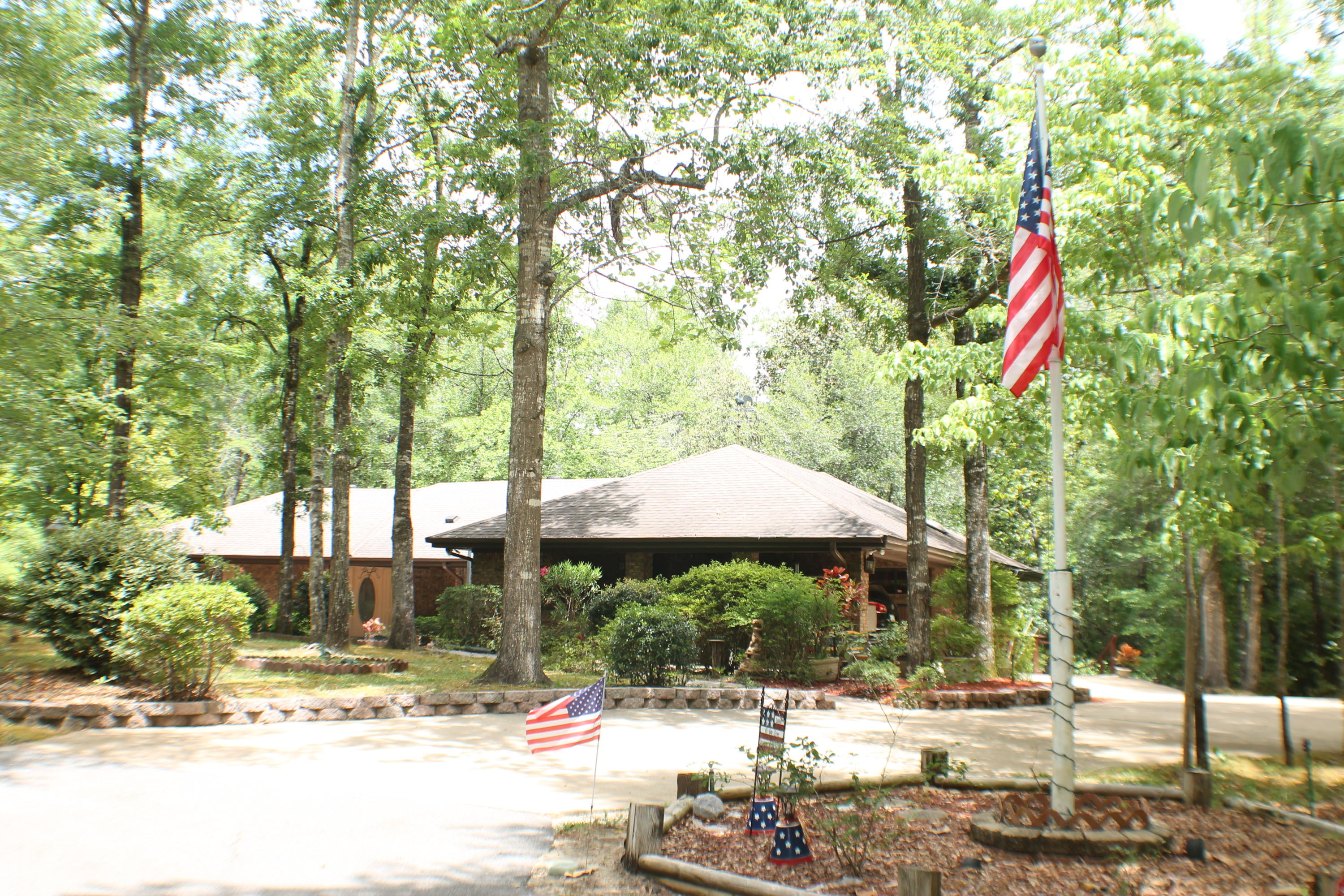 Welcome to Peace and Tranquility! Private pond, Stream with 2 water falls and 5 Acres! Listen to the Water fall from the back porch or the master bedroom window! Mountain retreat privacy 5 minutes from Shopping, schools and Restaurants! This home is like living in the outdoors with comfort of home! The huge picture windows give natural light the rooms! Enjoy the red birds, humming birds and the deer from the comfort of the home! Chef's kitchen huge panty and open living area with pass through windows to the screen porch allow a perfect family setting or entertainment area! Out side you will find full control of the pond which is stocked with Bream and bass. Around the property there are tons of blueberry bushes, scuppernongs, two wells ,one for irrigation.