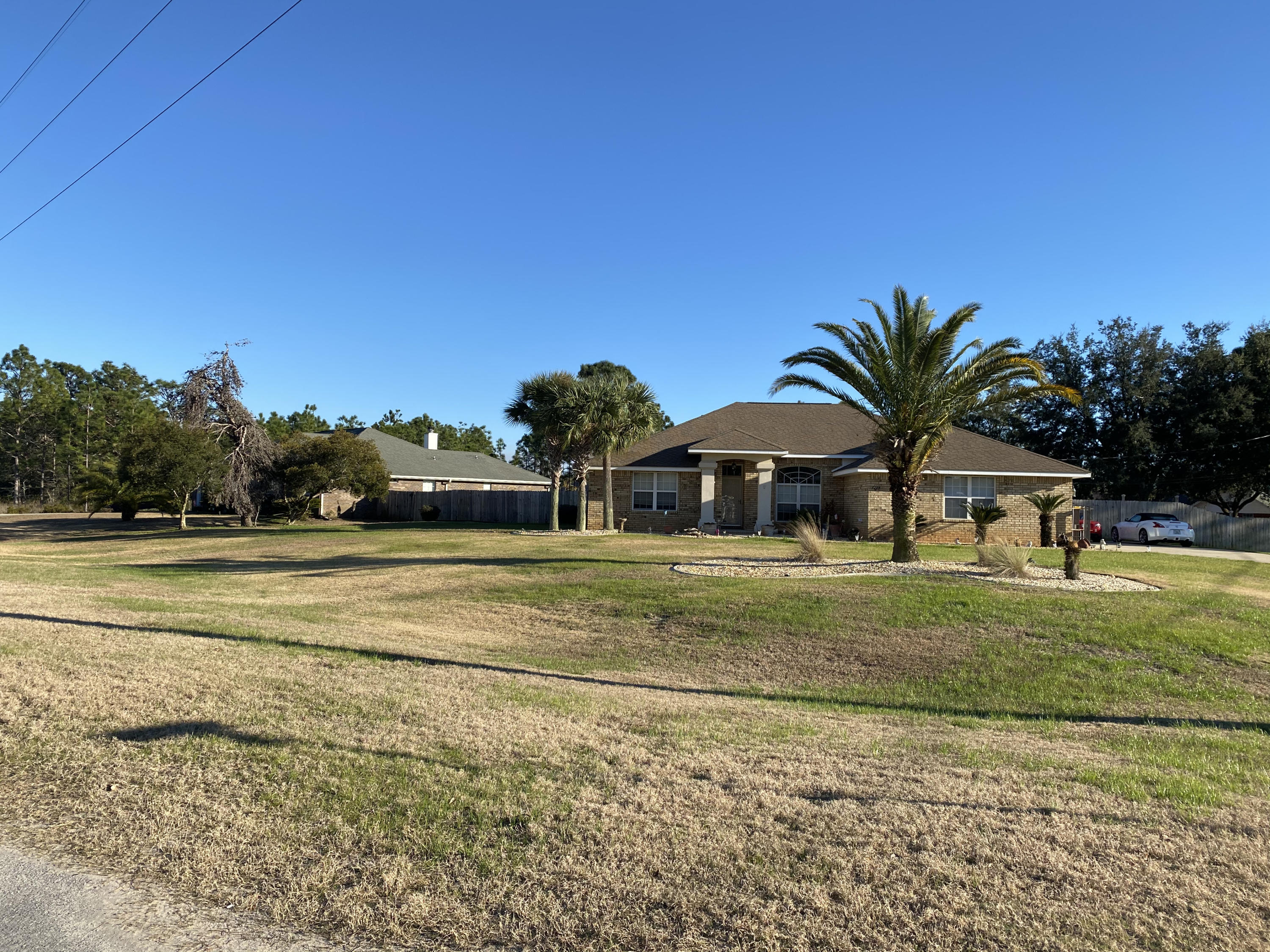 If you're searching for your own backyard oasis, then look no more! This beautiful POOL home in Holley By The Sea, boasts hardwood floors and ceramic tile throughout. The high ceilings and large open floor plan are perfect for large families. This home features a security system and pestguard protection and sits on well-maintained corner lot. Access to Community Recreation Center. Pool, BBQ Etc..