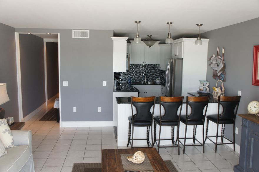 COMPLETELY REMODELED 1 BEDROOM / 1.5 BATH! $30,000+ IN UPGRADES AND PRICED TO SELL! NEW FURNISHINGS! NEW APPLIANCES! NEW HVAC! NEW HOT WATER HEATER. The most impressive feature of this condo is the hardwood floors (truly unique color with a premium finish that shines like a diamond). When you walk into this plush condo, look to your left and French doors open to an professionally decorated master bedroom with access to a private bathroom. The hallway has custom bunk beds that were meticulously installed for extra sleeping space. Custom 12x12 tile, granite countertops, Whirlpool side-by-side refrigerator, Whirlpool Gold Series Dishwasher, Whirlpool easy clean stove and oven, premium Elkay sinks, custom kitchen cabinets and backsplash, built in shelving, etc.