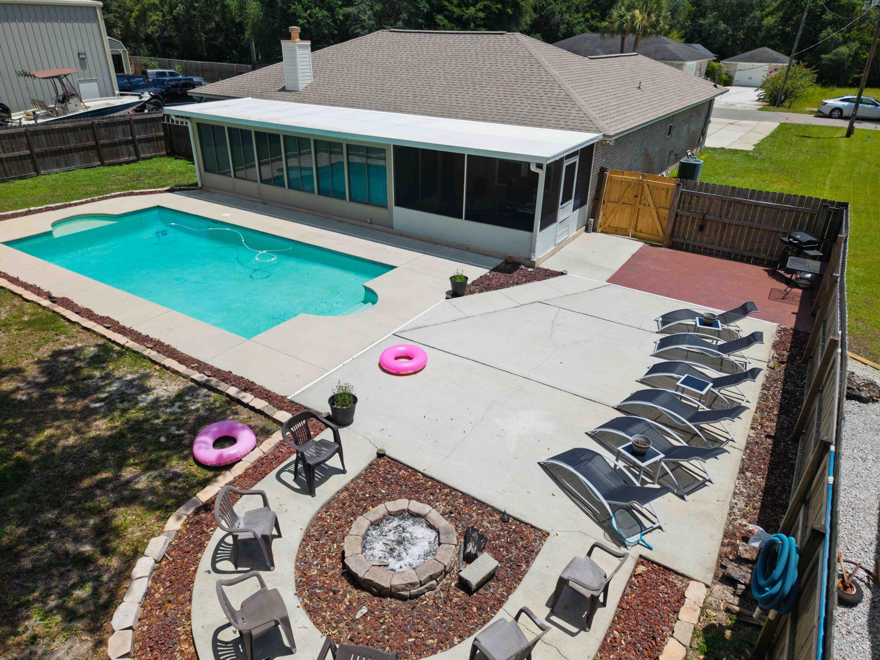 3147 Hickory - This home delivers the ultimate Florida lifestyle. Dive into your private pool, gather around the custom stone fire pit, and enjoy a sprawling fenced backyard built for entertaining. Total privacy, plenty of space, and endless potential for fun or relaxation. Located just minutes from a public dock, stunning white-sand beaches, and some of Navarre's best restaurants. With an easy commute to Pensacola, Destin, and bases across Northwest Florida, this home blends resort-style living with real-world convenience. Sunsets, beach days, and unforgettable nights start here--don't let it get away.