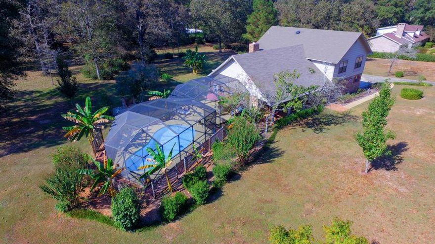 (Interior photos coming soon) You'll love more space, acreage and pool!  From the open kitchen/eating area to liberally-sized formal dining & living room to an expanded family room with gas fire place. This 4/3 on 1.87 acres has space for living and lounging.  Two main bedrooms & bathrooms, one on each floor! Additional bedrooms are large with large closets.  Kitchen has stainless appliances, smooth top stove, solid surface counters. Off the kitchen is the screened enclosed 10,000 gallon in-ground pool, with expansive bbq/bar area.  Family room has a beautiful attached screened porch overlooking the fenced yard. Laundry area with sink is close to the garage, 2 car garage has a large storage room that can house a freezer, tools, and sporting goods.  More details....