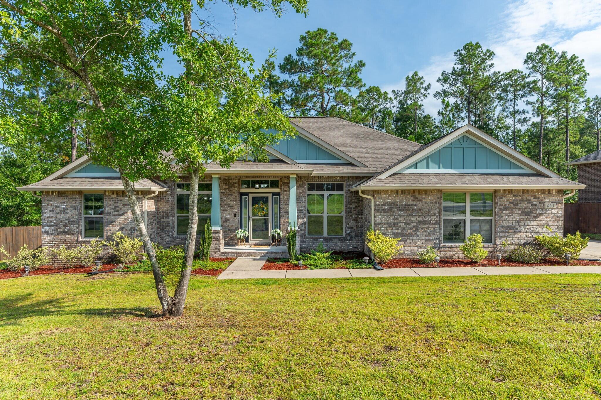 Welcome to Fox Valley! Perfectly situated on the south end of Crestview, this beautifully maintained home offers quick access to local military bases, shopping, and white-sand beaches of the Emerald Coast. Inside , you'll find brand new LVP flooring throughout-absolutely NO CARPET!! This spacious 4-bedroom , 3- full bath home features 11'' ceilings, a beautifully designed kitchen with granite countertops, island, under-cabinet lighting , custom shelving in the walk-in pantry, and a brand new kitchen island pendant lights that add a stylish and modern touch. The living rm showcases a custom built-in electric fireplace, bringing warmth and character to the heart of the home. There's also a flex space w/ French doors , ideal for a home office, playroom, or guest area. Step outside to your large screened-in back porch overlooking a freshly sodded (.35 acre lot) fenced backyard with plenty of room to add your dream pool. Additional highlights include gutters and an Assumable VA loan @ 5.25 %. Tucked away at the back of the sought after Fox Valley neighborhood , this home is truly move-in ready and waiting for it's next chapter . Call today or bring your favorite realtor - this one won't last !