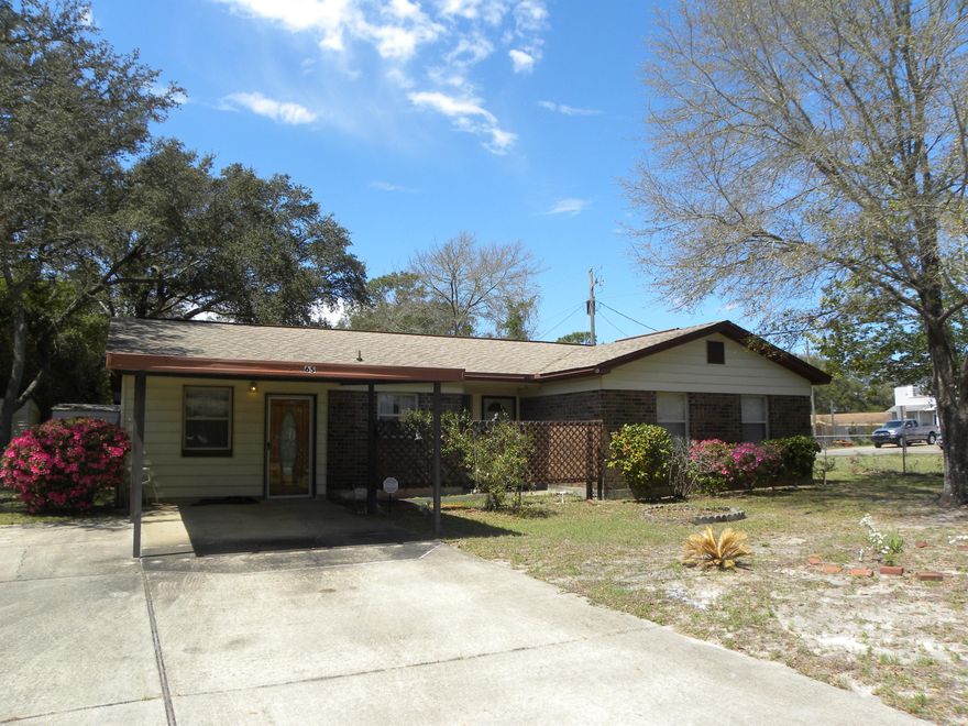 FANTASTIC HOME SITUATED ON A LARGE CORNER LOT IN THE HEART OF SHALIMAR! PRICE REDUCED FOR A QUICK SELL...Seller will look at all reasonable offers. Spacious cozy family room with a door that leads out to a large 33ft x 10ft screened-in patio and backyard. The kitchen is truly the heart of this home with beautiful granite counter tops to include a long buffet bar, designer backsplash, lots of custom cabinets, upgraded appliances to include a smooth top stove. Living area has a sliding glass door to access the screened-in patio. Dining area is open to the living room perfect for entertaining. Master bedroom has a half bath. Newer water heater. Freshly painted inside and new flooring to give it a sparkling new look! You will love to sit and relax on your large screened-in patio.