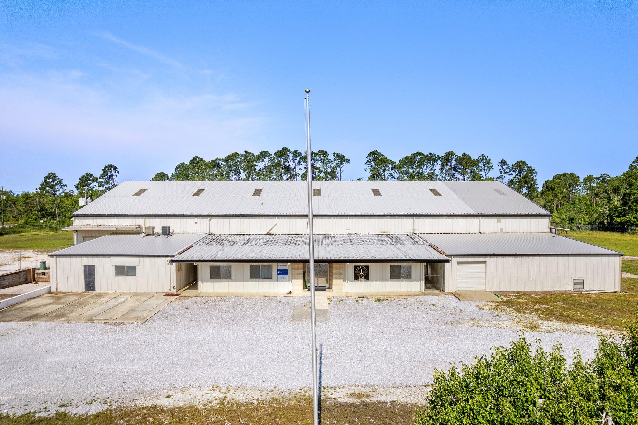 Excellent corporate industrial site includes fenced acreage, steel warehouse, offices. This is a 3.5 acre parcel within Panama City that is classified industrial property with a 19,476 sf building and helipad. The building has large doors on both ends. Possible property uses include: warehouse, defense contractors, suppliers, distribution, R&D, trades contractors, road work contractors, many possible uses with fenced spacious yard. Features include: #1 40' wide x 20' tall opening. Center ceiling height 32'. #5 - 15' wide by 14' high bays. #1 15' wide bay x 9' high. #1-20' wide bay x 9' high. It has 3 phase 1200 AMP service with outstanding lighting and plumbed air lines.