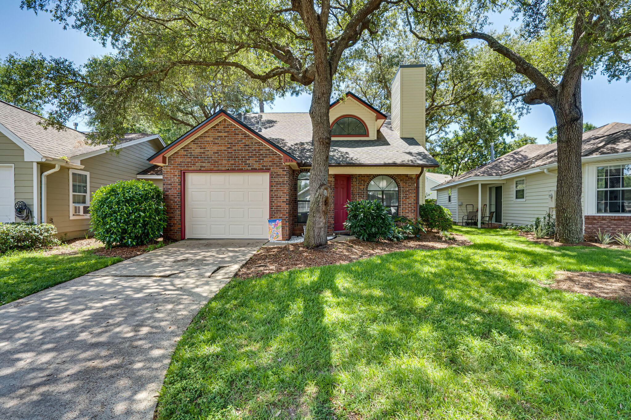 AFFORDABLE BLUEWATER BAY FLORIDA COTTAGE!! Welcome to Parkwood Circle, a community of quaint single and two story residences. This home is a two story brick front home with the master bedroom and bath on the first floor. It features a one car garage with brand new garage door and an easily maintained privacy fenced rear yard. This is the perfect starter home, rental, those on the go or for the empty nester as the HOA maintains both the yard trimming and watering, making it super easy to pack up and go on vacation whenever you desire! Upstairs there are two bedrooms and another full bath. The washer and dryer connection are located in the garage and the kitchen features a breakfast bar overlooking the breakfast nook and slider to the rear yard. Call your REALTOR to schedule an appointment!