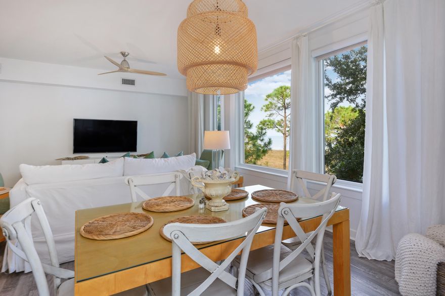 Spacious renovated corner condo with picturesque bay views. Largest 1 bed/1bath floor plan in Bahia. Updates include engineered wood floor throughout, double vanity and penny tile in bathroom, gourmet kitchen sink, quartz counters with waterfall edge, and designer furnishings. New HVAC (2021), full-size w/d (2020), and larger water heater (2019). The condo features raised ceilings, a large rounded private corner balcony that opens up to both the bedroom and dining room, spacious closet, oversized windows showcasing the lush bay views. Amenities of Bahia include swimming pool, hot tub, exercise room, indoor parking, and access to the Solstice Club. Sandestin offers 4 golf courses, tennis center, marina, gorgeous sugar white sand beaches, dining, shopping, and entertainment.