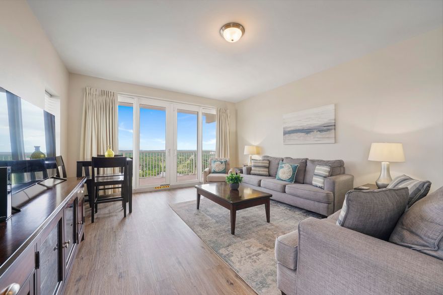 The best priced 3 bedroom condo in a short-term rental friendly building in Panama City Beach! This three - bedroom, lake-view condo with a wraparound balcony is turnkey and is ready to be enjoyed as a rental investment or a second home. $50- $60K projected. This is an end unit, positioned to receive multiple water views: the lake, partial gulf views, and St. Andrew's Bay. Enjoy the nightly fountain light show on the lake with family on the enormous wrap around balcony. The unit has recently been upgraded with durable luxury vinyl plank flooring in the living area and bedrooms. Unit also includes a new hot water heater and up to date dehumidifier. With fun beachy furnishings and decor, this unit is an idyllic Panama City Beach destination and a great value. Priced to sell! See it today!