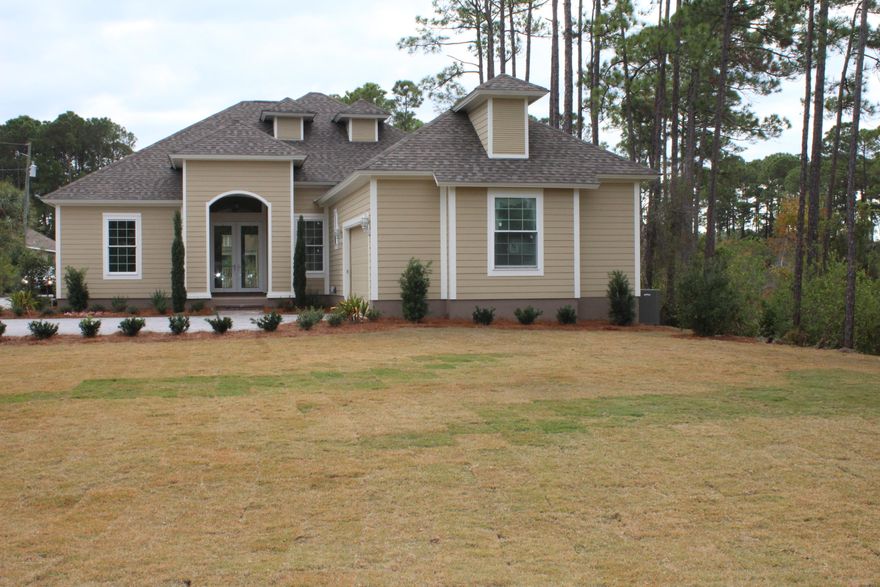 Brand new outstanding home on a half acre lot 30 days until completion!. Peaceful surrondings. Hurricane rated windows, X zone no flood insurance. 14 x 37 deck, 10'4' ceilings, solid wood cabinets, granite counter tops, travertine and wood laminate floors, master bath with Jacuzzi tub his & her sinks, walk-in marble shower, Hurricane windows & doors, decorative arches through out. 8ft doors. Kohler plumbing fixtures, huge lot with big front yard, back yard room for a very private deck or pool, hardy board on the exterior, 2 x 6 construction, huge windows, double glass front doors, transom windows, crown molding, coffeur ceilings. Trimed out windows and doors. Huge back yard. Room for pool and/or storage shed. Back yard all sodded and landscaped.