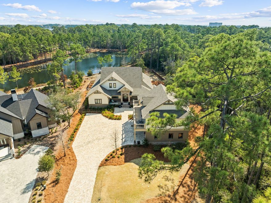 Welcome to 1400 Otter Point, a rare opportunity to own one of the most exceptional properties in the prestigious, gated Wild Heron community--nestled along the shores of Florida's largest coastal dune lake, Lake Powell. This luxurious coastal craftsman estate sits on an oversized, private lot with serene pond views, blending refined design with resort-style living. Step inside to find a custom-designed kitchen that will impress even the most discerning chef--complete with top-of-the-line appliances, exquisite cabinetry, and an elegant island perfect for entertaining. The expansive living areas flow effortlessly to the outdoors, creating a seamless connection between indoor sophistication and outdoor enjoyment. The primary suite offers a peaceful retreat with a spacious spa-inspired bath and and a large custom walk-in closet designed for luxury and functionality. Guests will love the carriage house with a 3-car garage, offering versatility and privacy for extended stays or a studio space. Outdoors, the property transforms into an entertainer's dreamfeaturing a fully equipped outdoor kitchen, covered living space, and tranquil pond views surrounded by lush, mature landscaping. Located in one of the Emerald Coast's most sought-after gated communities, residents of Wild Heron enjoy access to Lake Powell, resort style amenities, and the best of coastal luxury living on the west end of Panama City Beach. 1400 Otter Point is not just a homeit's a lifestyle of elegance, comfort, and privacy.