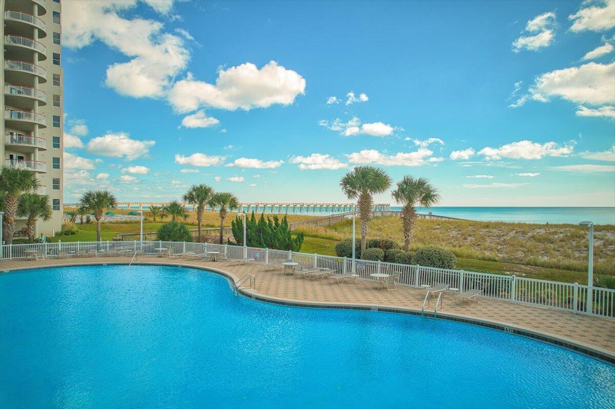 Welcome to Just Beachy, a beautifully appointed 13th-floor, 3-bedroom, 3-bath condo in Beach Colony West that delivers breathtaking, panoramic views of the Emerald Coast. This Gulf-front retreat comfortably sleeps 8 and grossed $75K in 2024, with bookings already secured for August, September, and October. Offered fully furnished and turnkey, it's ideal as a secondary home, primary or high-performing investment property.Step inside to find tasteful Coastal Cottage decor, an open layout, and tile flooring throughout. The spacious master suite features a luxurious jetted tub with windows overlooking the sand and surf, creating a dreamy, spa-like escape. The gourmet kitchen is equipped with granite countertops and everything needed for effortless entertaining. Enjoy the Gulf breeze and unforgettable sunsets from your private circular terrace. Beach Colony is known for its trend-setting architecture, private entryways, and resort-style amenities; including covered parking, tennis and pickleball courts, a fitness center, and the island's largest swimming pool. Anglers will love being just a short walk from the Navarre Beach Fishing Pier.
Whether you're sipping coffee on the balcony, soaking up the sun poolside, or listening to the waves crash below, Just Beachy offers a lifestyle like no other.