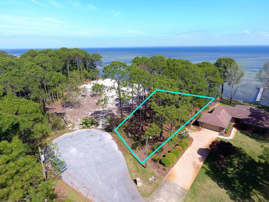 Fabulous cul-de-sac lot located in the quiet community of Holiday Shores. This lot is over acre and and offers over 150 feet of water frontage. Plenty of space for a dock. This private lot features expansive western views of the Choctawhatchee Bay. The Choctawhatchee Bay provides exceptional year-round fishing, boating opportunities, and amazing wildlife. Easy access to the Gulf of Mexico, Destin Pass and Intercoastal Waterway. Perfect location to build your bay front dream home!