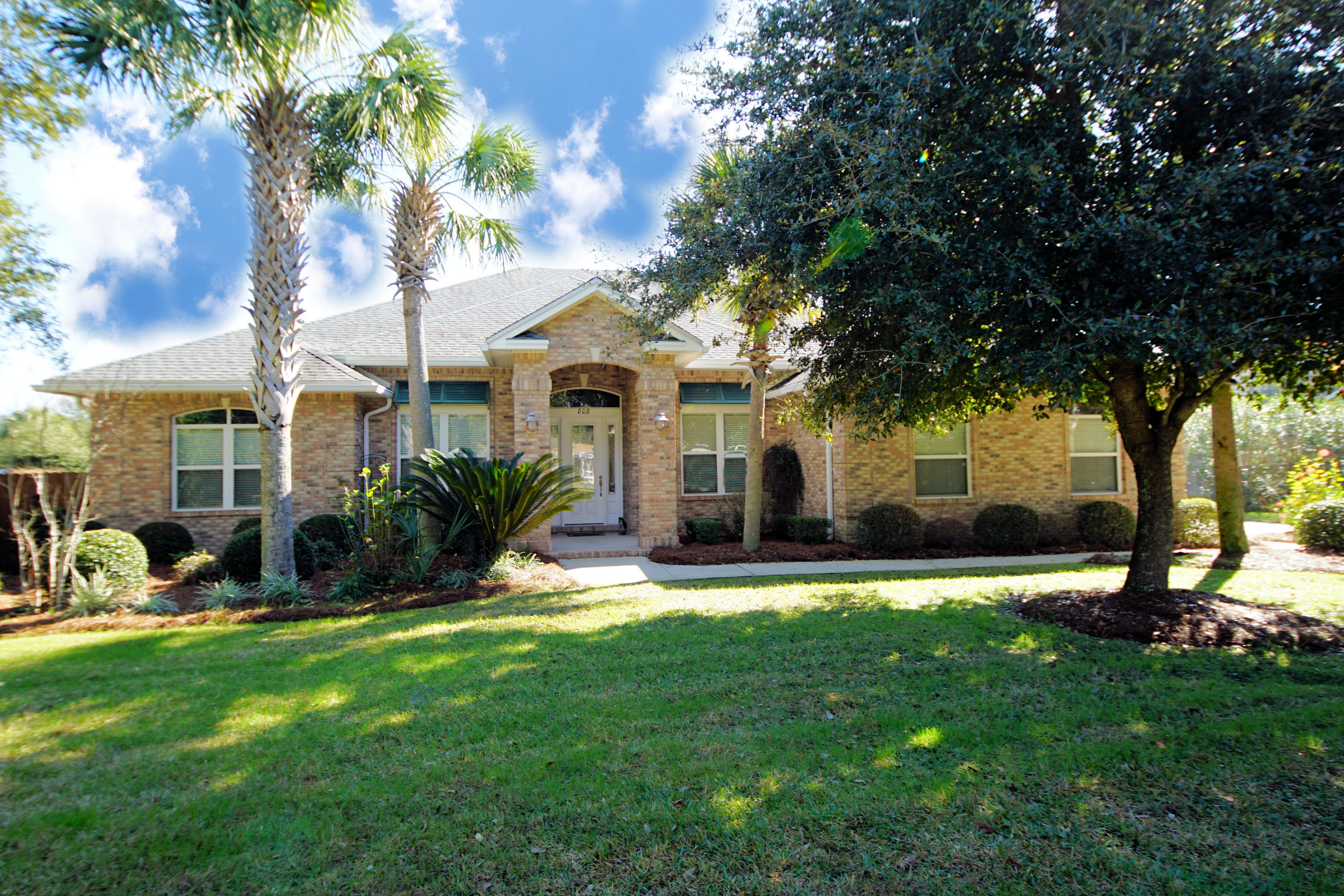 This beautifully maintained home is a fortress. Constructed with ICF-(ECO-Block) and brick exterior it's built to withstand the Panhandles weather and be energy efficient. Upon entering the spacious foyer you are welcomed into a home that promotes the Florida lifestyle. The office is enhanced with custom cabinetry, a built in desk,and French doors. Faux finished walls in the dining room provide a beautiful backdrop to entertain your friends and family. The kitchen boasts granite countertops, breakfast bar, stainless steel appliances, large eat-in area, storage galore and is open to the great room. The great room has a built in entertainment center and a fabulous view of the back yard. Sit and relax on the large covered back porch overlooking the sparkling gunite pool and lushly landscaped