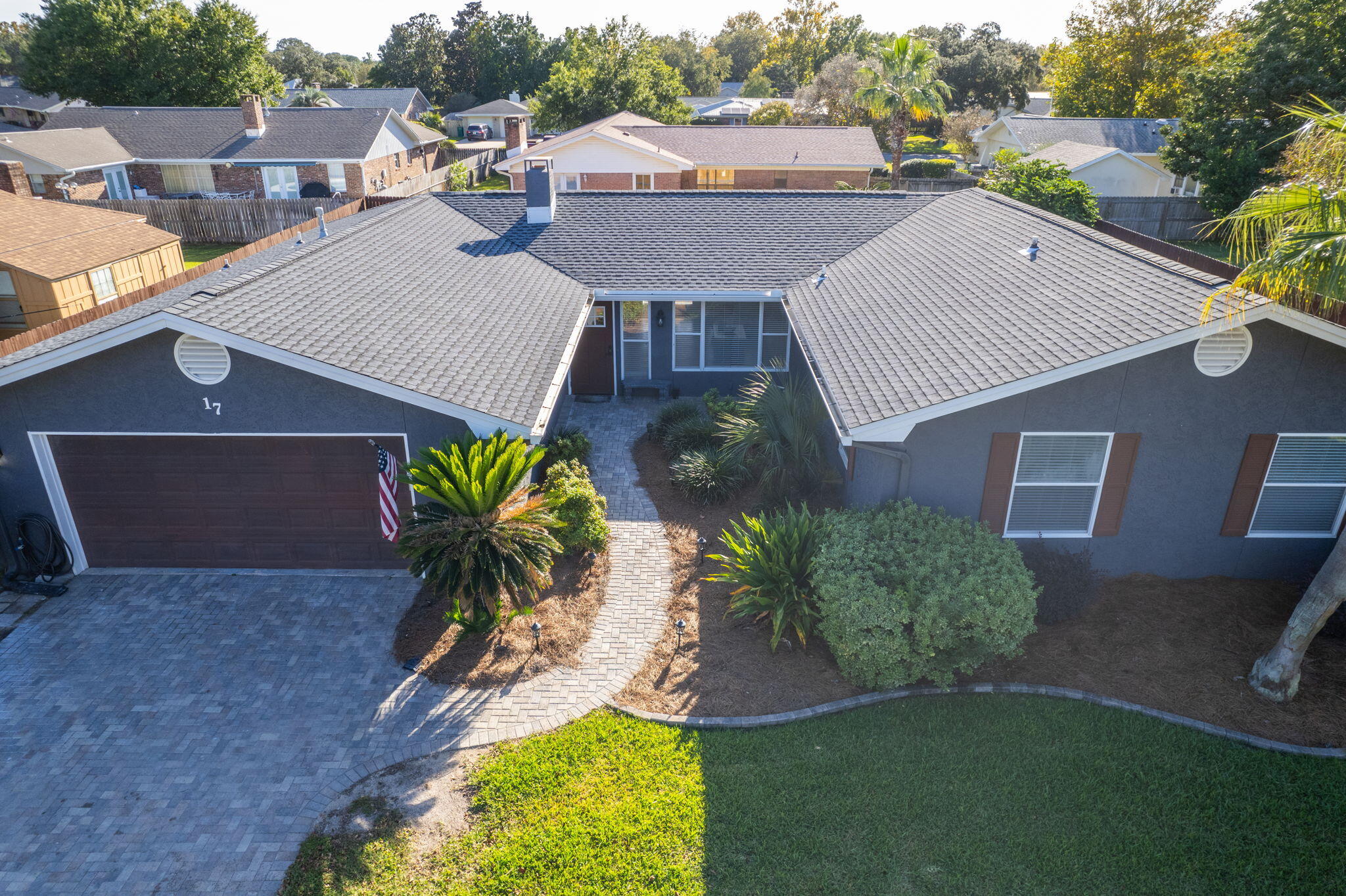 Stunning Pool Home in Lake Lorraine, Shalimar, FL - Prime Location Near Eglin AFB & Crab Island. Welcome to 17 Pebble Beach Drive, a beautifully updated home located in the highly desirable Lake Lorraine neighborhood of Shalimar, Florida. This home offers both modern upgrades and timeless charm, all within close proximity to top-tier recreation and essential amenities. Perfectly situated just 4 miles from Eglin Air Force Base, 12 miles from Hurlburt Field, and a short drive or boat ride to the famous Crab Island, this property is ideal for those who enjoy the Emerald Coast lifestyle and need easy access to military bases. This 4-bedroom, 2-bathroom home is set on a beautifully landscaped lot with mature trees and curb-appealing greenery. Upon entering, you are welcomed into a large, open living room with French doors that lead directly to the in-ground pool and custom-designed brick paver patio complete with built-in benches. The expansive covered patio spans the full length of the home, perfect for entertaining or relaxing by the pool. A paver path leads from the back to the side gate, enhancing accessibility, while a French drain in the pavers near the house helps prevent water from collecting under the covered patio, ensuring a dry, comfortable space. The freshly painted stucco exterior features gutters to ensure optimal water runoff, while the fully fenced backyard provides privacy for your outdoor oasis. This home has seen recent upgrades, including a new roof (2023) by Specialty Roofers, a new lawn pump (2024), and a new pool pump (2023). The 2020 vinyl pool liner installed by Panhandle Pool ensures years of enjoyment. Inside, the home features a remodeled tile fireplace, wood-like tile floors in the living and dining areas, and new carpet throughout. The kitchen is a chef's delight, boasting granite countertops, a gas stove and oven, stainless steel appliances, a kitchen island, and numerous cabinets for ample storage. A built-in work area with a tile backsplash and custom desk makes for a functional home office space. Adjacent to the kitchen, the cozy breakfast nook features built-in benches with extra storage and stylish wainscotting-accented walls. The spacious master bedroom offers French doors that open directly to the pool, while the remodeled master bathroom boasts new tile flooring, glass shower doors, double vanities, and a glass-paneled French door leading to a large walk-in closet. Throughout the home, updated black fixtures add a modern touch, complementing the home's fresh look. Other highlights include crown molding, recessed lighting, and remodeled bathrooms. The brick paver driveway further enhances this home's inviting curb appeal. Location is everything, and this home is minutes from Shalimar Pointe Golf Course, local shopping, and dining. Plus, it's just a short drive to the pristine beaches of the Emerald Coast, Destin's entertainment, and the scenic parks surrounding Choctawhatchee Bay. 17 Pebble Beach Drive offers an exceptional blend of luxury, functionality, and convenience, making it perfect for a variety of lifestyles, whether you're stationed at a nearby base or looking for the ideal home on Florida's Gulf Coast. 