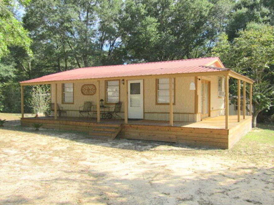 Escape to your own slice of country paradise in this charming Florida cottage, perfectly situated on a peaceful acre just north of town. Enjoy the ultimate blend of tranquility and convenience with low property taxes and NO HOA fees.This home is a unique treasure, featuring an expansive wrap-around porch where you can sip your morning coffee or enjoy a quiet evening. The durable metal roof provides peace of mind, and the property is easily accessed via a paved road. Inside, the heart of the home is a quaint, character-filled kitchen highlighted by a stunning, antique-style fridge and gas stove/electric imported from Europe--a true conversation piece and a dream for any home chef. If you're seeking a quiet retreat with rustic elegance, and a charming, relaxed lifestyle, this is the one. Come experience the best of Florida country living.