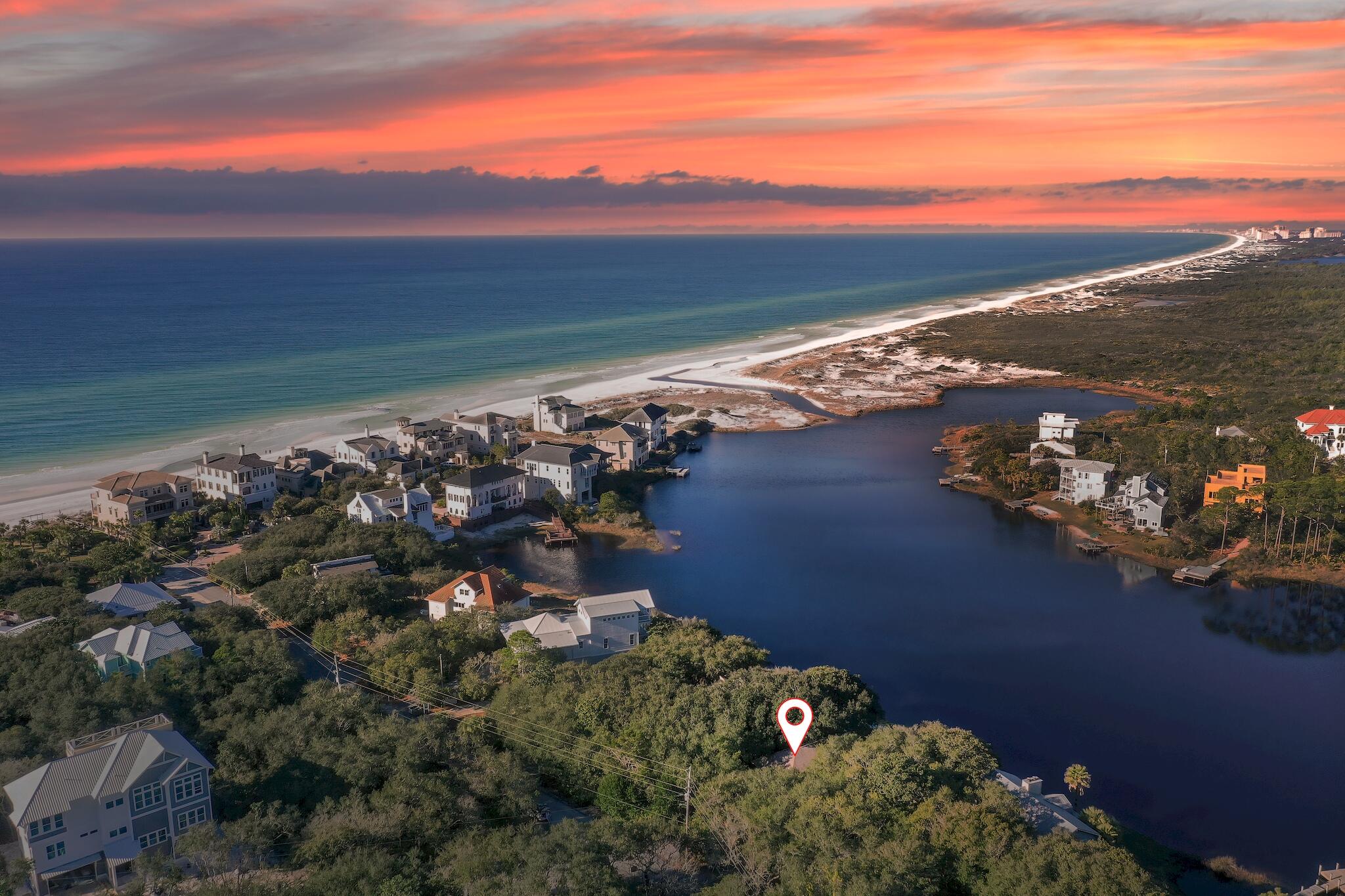 Nestled on Stallworth Lake, South of 30A, amongst the treetops of shaded Oaks, this magnificent property provides gorgeous lake & Gulf views, complete privacy AND beach access 250 yards away. Enjoy a morning paddle board ride across the lake to the white sandy beach at Topsail Preserve State Park, an afternoon in the crystal blue waters at the beach just steps away & watch the sun set over the Emerald Coast from your lakefront terrace. Exhale & unwind on 828 SF of balconies/terraces suspended in nature. Ideal as a primary home, beach house and/or vacation rental, this 3 BR/3 Bath cottage is sold fully furnished & turnkey. Sitting on large .38 acre lot, there's plenty of room to add on to current home or to start over. Other features include high vaulted ceiling, terra cotta flooring, NO HOA fees, parking for 8+ vehicles in large covered carport & long driveway, exterior storage closets for beach toys, handicap accessible shower & ramp accessing home and outdoor shower. Perfectly located just off of 30A, Grand BLVD & Silversands outlet mall are minutes away, golf is nearby, and the fantastic shops & fine dining at Gulf Place, Seagrove & Seaside are a short ride away.  Act now as this unique oasis amongst the shaded treetops won't last long. 