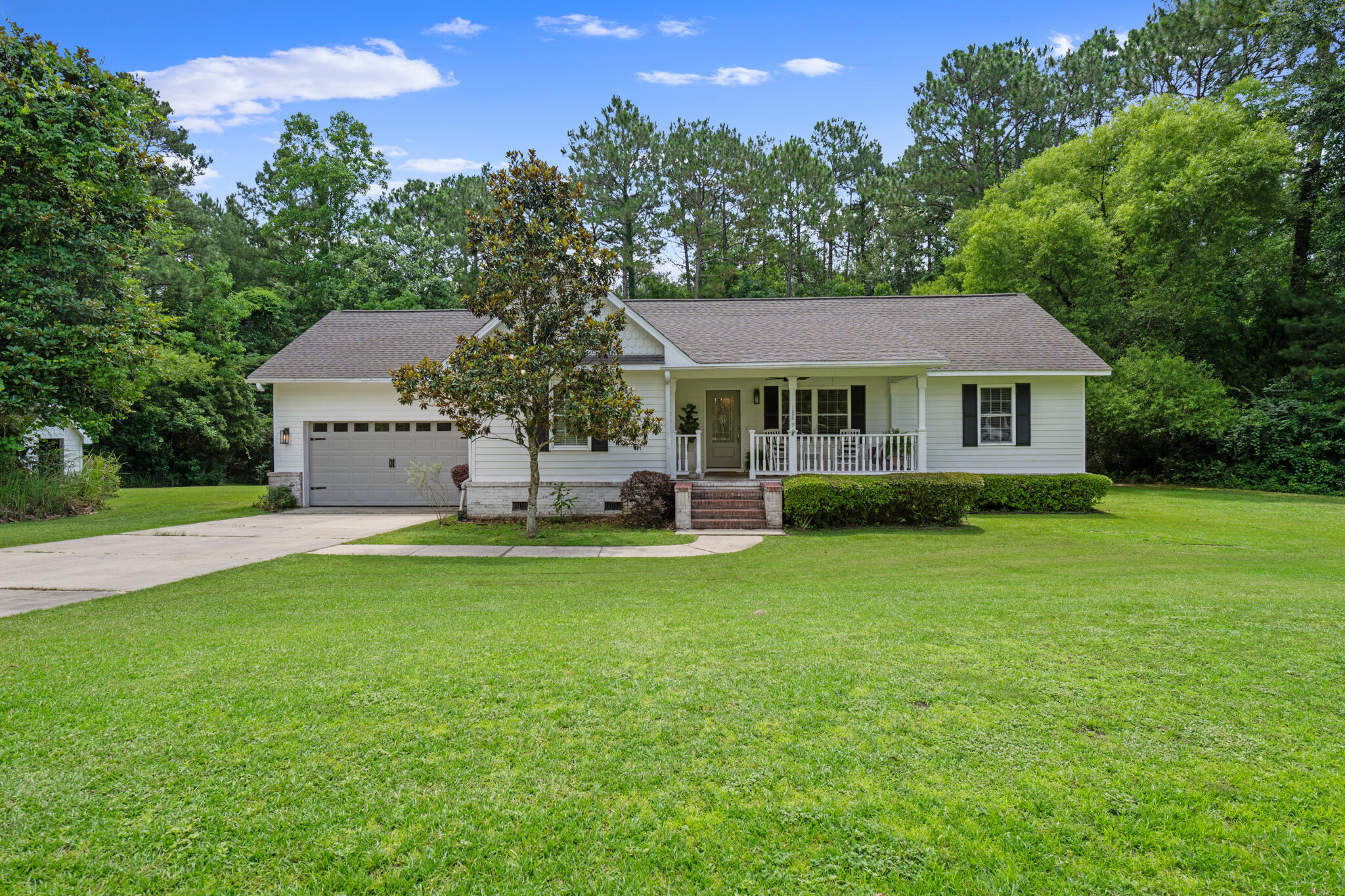 Welcome to this inviting 3-bedroom, 2-bath residence located in DeFuniak Springs. Set on a peaceful wooded lot, this home offers the perfect blend of comfort and charm. You'll appreciate the beautifully landscaped yard and covered front porch, that creates an inviting entry.Inside, you'll find an open floor plan with vaulted ceilings and hardwood flooring in the main living area. The detailed trim work and craftsmanship throughout the home adds beautiful character. The split-bedroom layout provides privacy. A covered back porch just off the kitchen offers the perfect space for outdoor dining or morning coffee.Schedule your showing today and come experience the comfort and charm it has to offer!