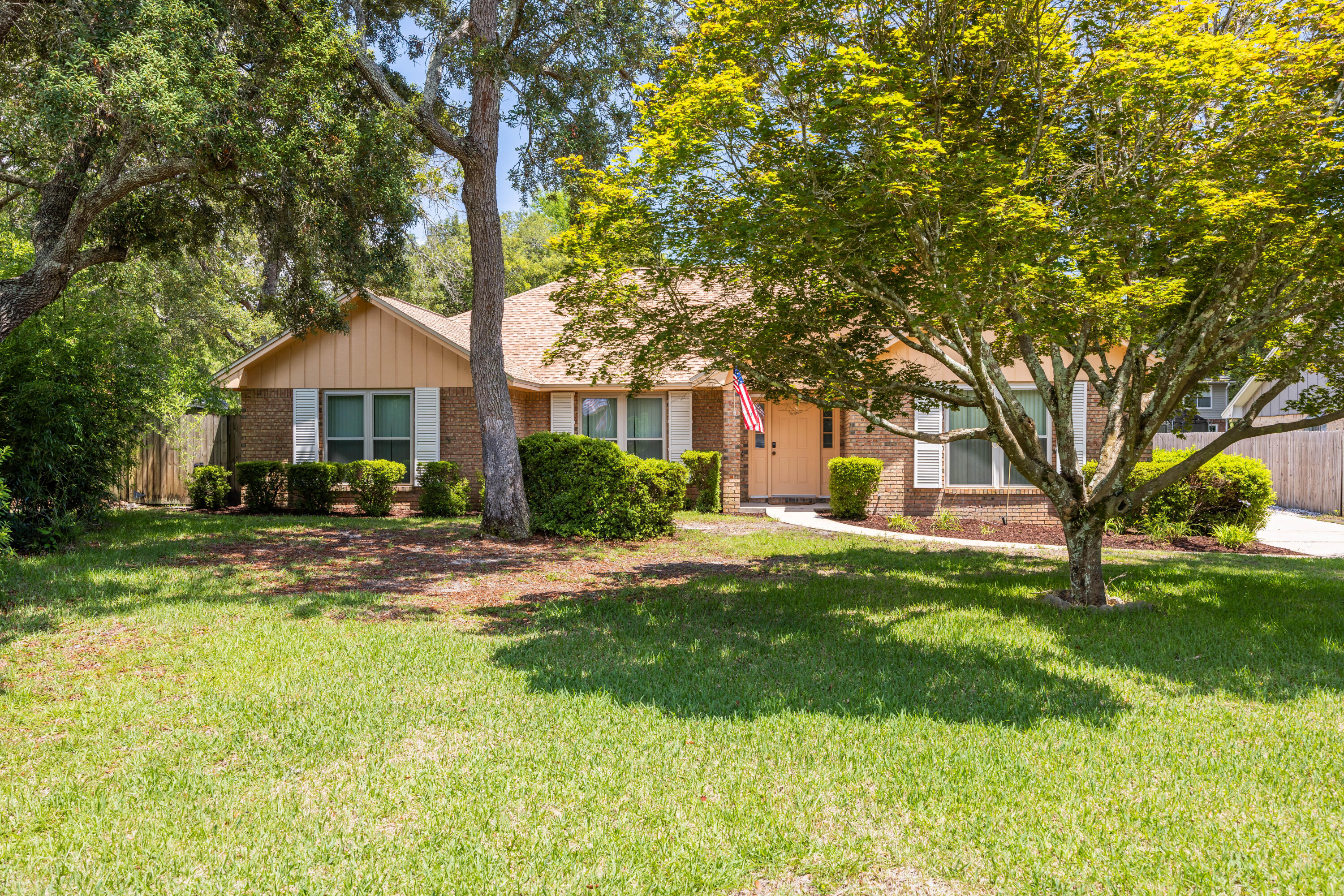 Come see this one-of-a-kind floor plan in Bluewater Bay with an oversized rear-entry garage for added privacy & convenience. Recent updates include a newer roof, windows, A/C, water heater, & irrigation pump, offering peace of mind for years to come. Spacious living area with wood burning fireplace, dining area, well-equipped kitchen with eat-in kitchen area & laundry closet. Florida room to to enjoy the sunlight. Split bedroom plan with 3 bedrooms & bath, master suite with double vanities. Hurricane shutters for protection. Backyard is perfect for kids play, grilling or relaxing under mature trees. Azaleas surround the home and camilla bushes, hydrangeas and lilies are in bloom during the Spring/Summer. Ideally located near top-rated schools, parks, and bases. Offered as-is.