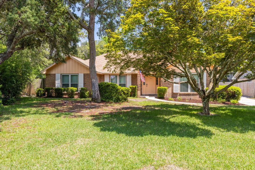 Come see this one-of-a-kind floor plan in Bluewater Bay with an oversized rear-entry garage for added privacy & convenience. Recent updates include a newer roof, windows, A/C, water heater, & irrigation pump, offering peace of mind for years to come.  Spacious living area with wood burning fireplace, dining area, kitchen with eat-in area & laundry closet.  Florida room to to enjoy the sunlight.  Split bedroom plan with 3 bedrooms & bath, master suite with double vanities.  Hurricane shutters for protection. Backyard is perfect for kids play, grilling or relaxing under mature trees. Azaleas surround the home and camilla bushes, hydrangeas and lilies are in bloom during the Spring/Summer. Ideally located near top-rated schools, parks, and bases.  Offered as-is