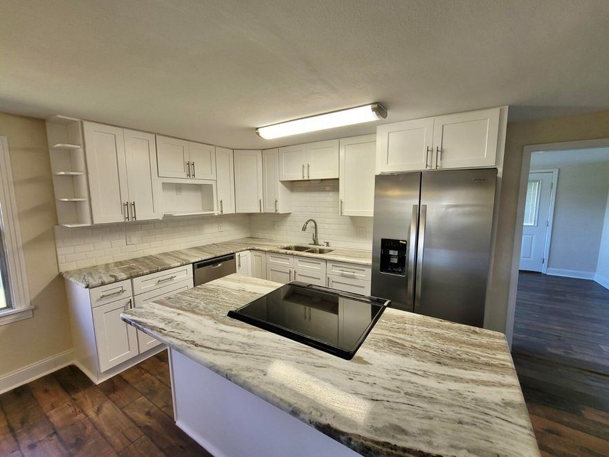 Renovated 3/1 Cozy Ranch home. Come sit on the Porch of your 1.03 Acres and relax!  Large Open New Kitchen with new cabinets, Granite counter-tops, Subway tile backsplash, New Stainless Steel Appliances. New laminate Floors in main areas, New Carpet in bedrooms and Luxury waterproof vinyl in bathroom, New Custom Bath, New lights and fans, New Plumbing, New electrical, New HVAC, New Septic.  Metal roof!!  Huge Pole barn and shed included but they are AS IS.