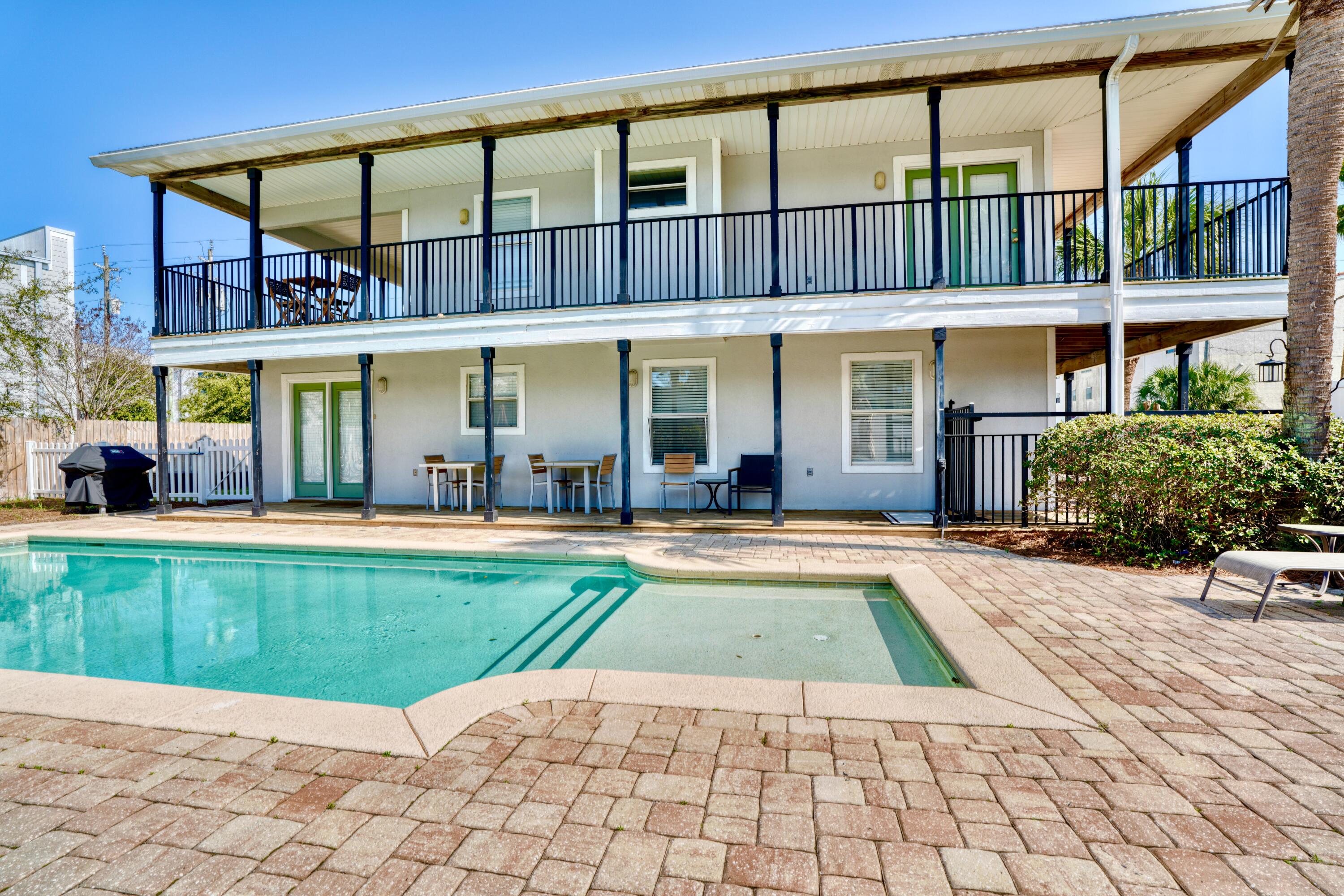 Stylish Costal Cottage Beach House with Private Heated Pool on a Premium Corner Extra Large Lot In an Exclusive Gulf-Front Neighborhood. This home is positioned steps to the beach and is Turn Key & Rental Ready Perfect for a Vacation Home, or make this beauty your Second Home or Full time Residence.  Beautifully Landscaped Tropical Lush Backyard Oasis with a Privacy Fence Surrounding. The Serene Gunite Pool & Generous Grilling/Entertaining Area does not disappoint as there is plenty of room for the kids and dogs to run and play! Windancer Shores conveniently hosts a private gated beach access, beach chair service and a gulf-front community pool with bathroom facilities. This Seaside Retreat is Perched on a Generous lot with abundant parking, there is potential to build a garage with Apartment above, Carriage House, Granny Pod etc. for expansion. Inside you will delight in several fine features to include new flooring, new appliances, fresh paint, a cozy fireplace and french doors in every bedroom leading out to the abundance of wrap around porches allowing for prime enjoyment outdoor this coastal charmer. Superbly located, hop on your golf cart or bikes and there are miles to enjoy quaint beach shops, an outlet mall, restaurants, ice cream shops, coffee shops, etc. even a winery tasting room All while gazing at the spectacular emerald green waters and sugary white sands this area is famous for! Seize the opportunity now to secure this incredible memory maker and start living the dream beach life you so desire! You Deserve It! 