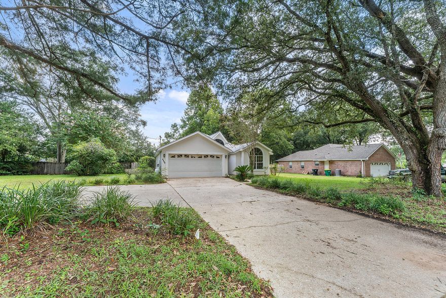 This could be your next home - a charming retreat offering a cozy yet spacious layout with 3 bedrooms, 2  full baths in 1,527 sq ft designed for effortless living on a double lot. Drive offers paved turn around with a 2 car attached garage and fenced backyard. A sunroom off the family room leads to the backyard with a pergola and yard building with room for family and pet activities, gardening, and/or soaking up the Florida sunshine and a pool if you wish to add one. Home has been freshly painted, roof updated 3.5 years ago. In Master bedroom you will find 2 walk-in closets, bath has jetted tub, separate shower along with double sinks.  Swinging doors separate the kitchen from the formal dining area with hutch and living room. The kitchen is down a hallway from entry area and has a new dishwasher, space for the refrigerator of your choice and a laundry closet across the hall.  Please take a look see.