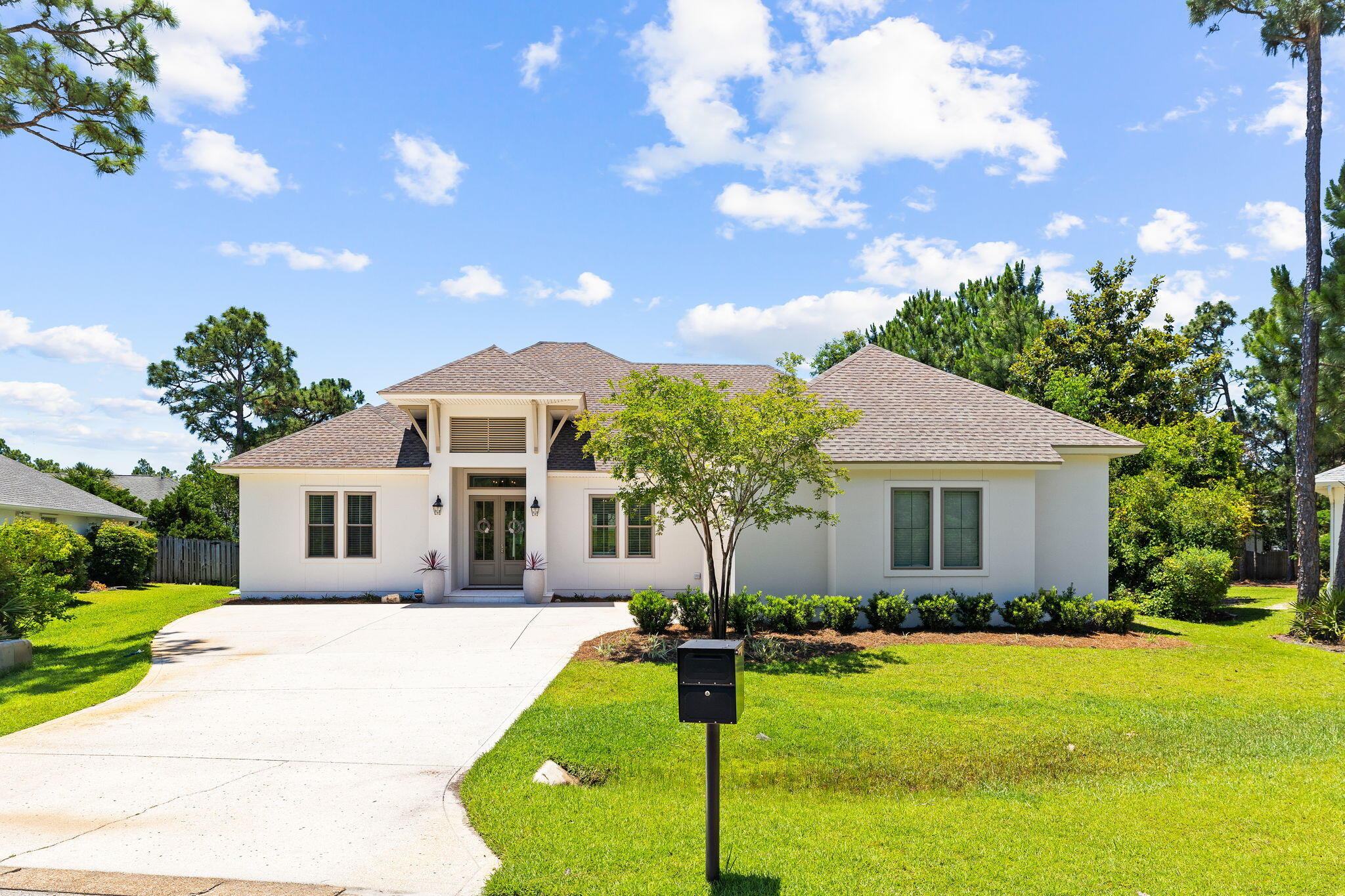 Welcome to 51 Morning Sun Court, a custom-built 4-bedroom home exuding elegance & luxury.  Newly constructed in 2019, this home is situated in the desirable Pelican Bay community, minutes from Choctawhatchee Bay.  This single-level residence features an open-concept floor plan and a spacious, fenced backyard.Upon entry, you are greeted by an expansive living area with soaring 14-foot cathedral ceilings with a cast stone mantle, and Pecky cypress accents in the foyer that extends to the kitchen and formal dining area.  The kitchen is equipped with quartz countertops, hood range, breakfast bar, and KitchenAid appliances. The master suite offers dual walk-in closets with built-in dressers and custom shelving.  The luxurious master bathroom features two separate vanities, standalone tub, a large walk-in tiled shower. Additionally, the home includes three guest suites and two full bathrooms, all appointed with quartz countertops and ceramic tile. The laundry area, just off the garage entrance, is outfitted with full countertops, a sink, and penny tile. The fenced backyard, with ample space for a private pool, is perfect for entertaining. This property is a rare gem in Santa Rosa Beach, featuring a meticulously maintained lot and proximity to schools, Grand Blvd, and the Gulf of Mexico. Pelican Bay amenities include a bayfront community park with a dock, picnic tables, and pickleball/tennis courts.