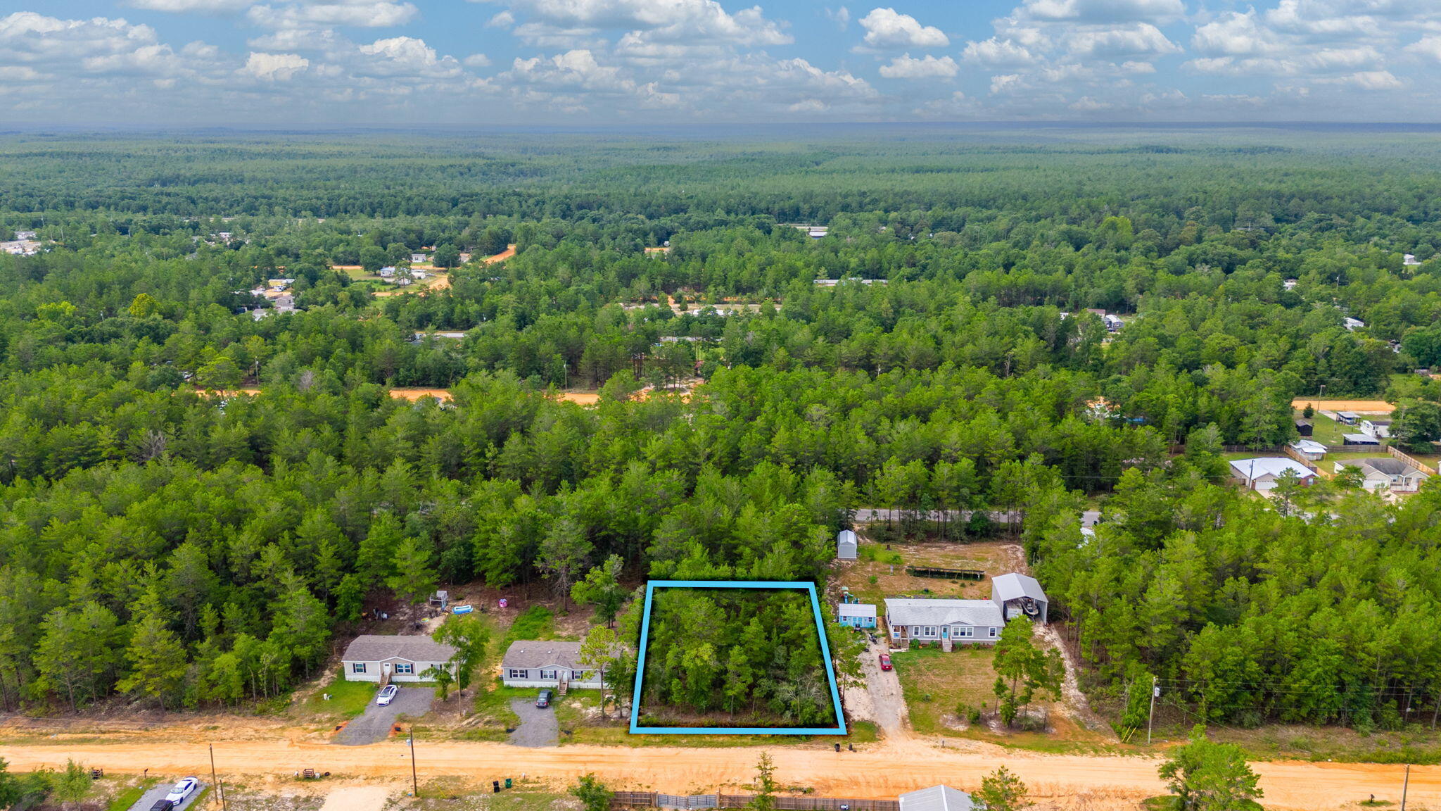 .23 acre lot in Oakwood Hills Unit 1. No restrictions mean limitless possibilities against a wooded backdrop. Manufactured homes are allowed. Level, flood zone x, & no wetlands according to the county GIS map. Power & water are available at the street. Tap fee is due to Mossy Head Water Works. A septic tank would be needed. Property is located on a county maintained dirt road, about 700 ft off of a paved road.